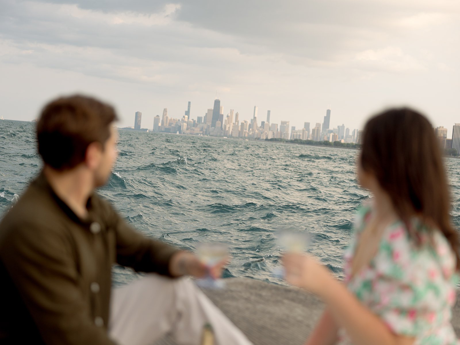 a couple drinking wine on lake michigan