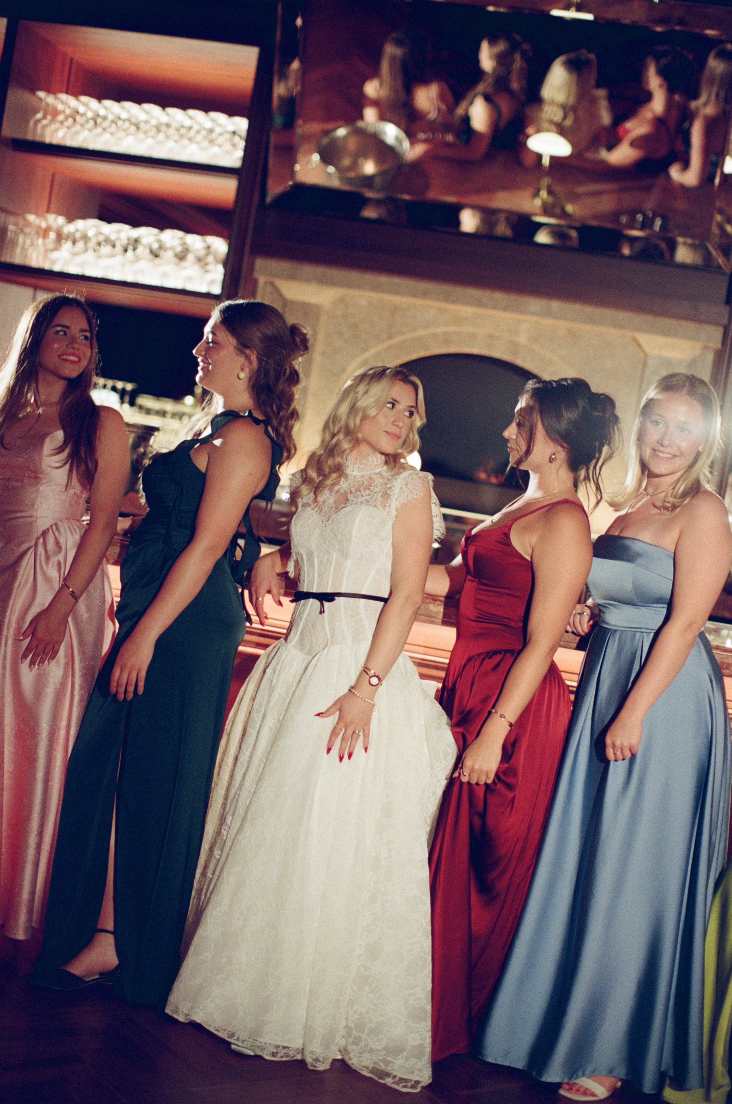 Bridesmaids laugh together candidly at the bar