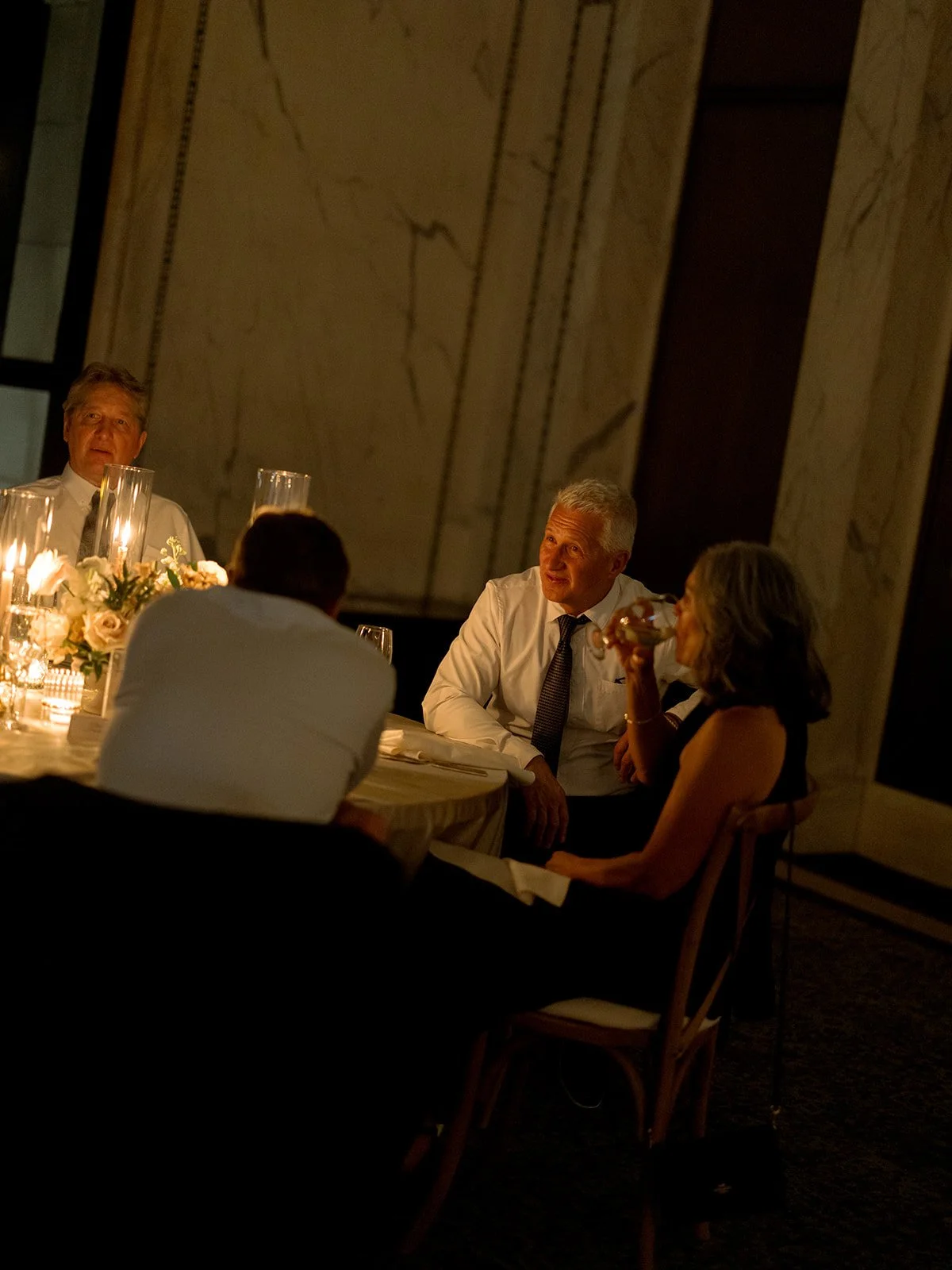 Guests sitting together at the reception, receiving a heartfelt toast during dinner. Shot on film by a Chicago wedding photographer.