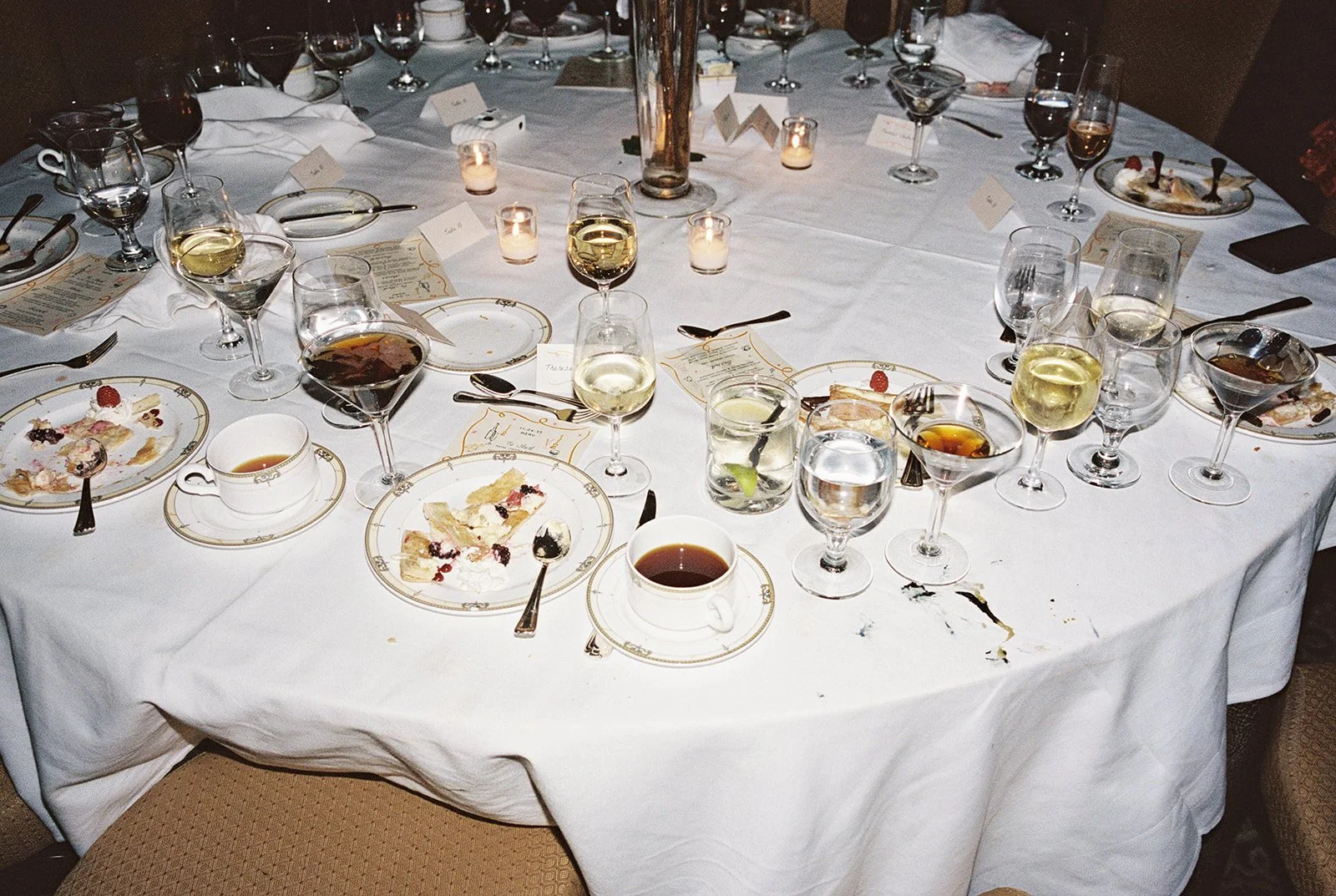 An end-of-night reception table tells its own story — half-empty wine glasses, espresso martini coupes, dessert plates, all the evidence of a truly great celebration at University Club Chicago. Shot on film by a Chicago film wedding photographer.
