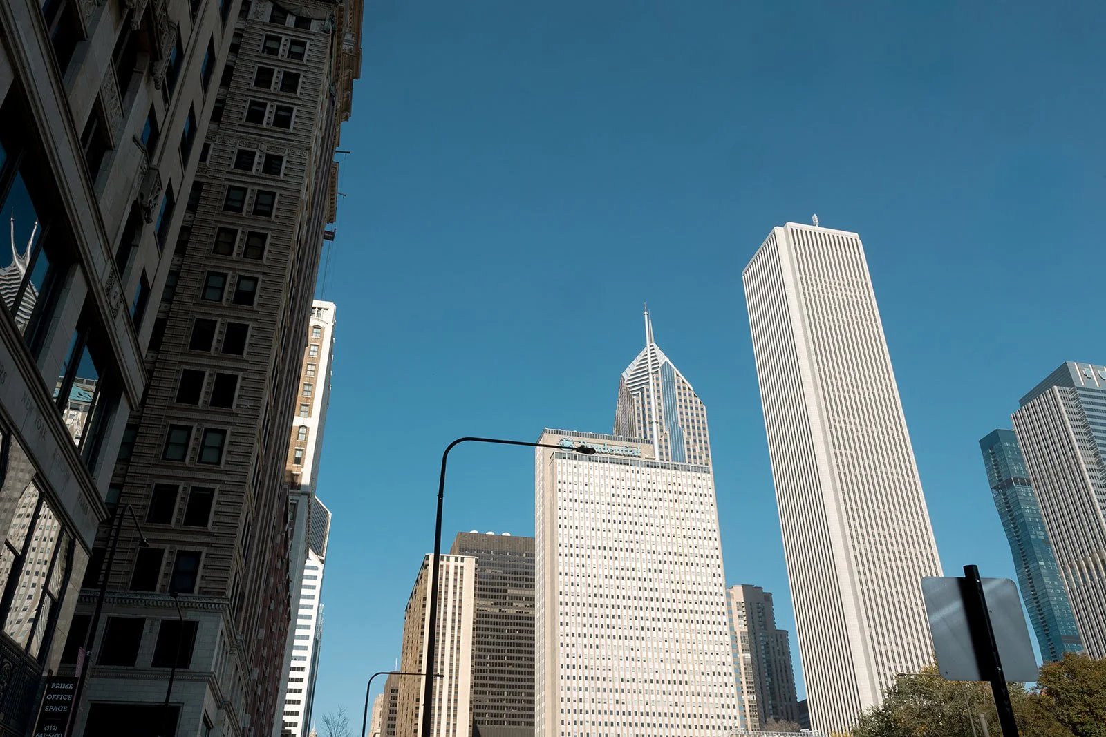 Chicago's iconic skyline with towering skyscrapers photographed in daylight. Shot on film by a Chicago wedding photographer.
