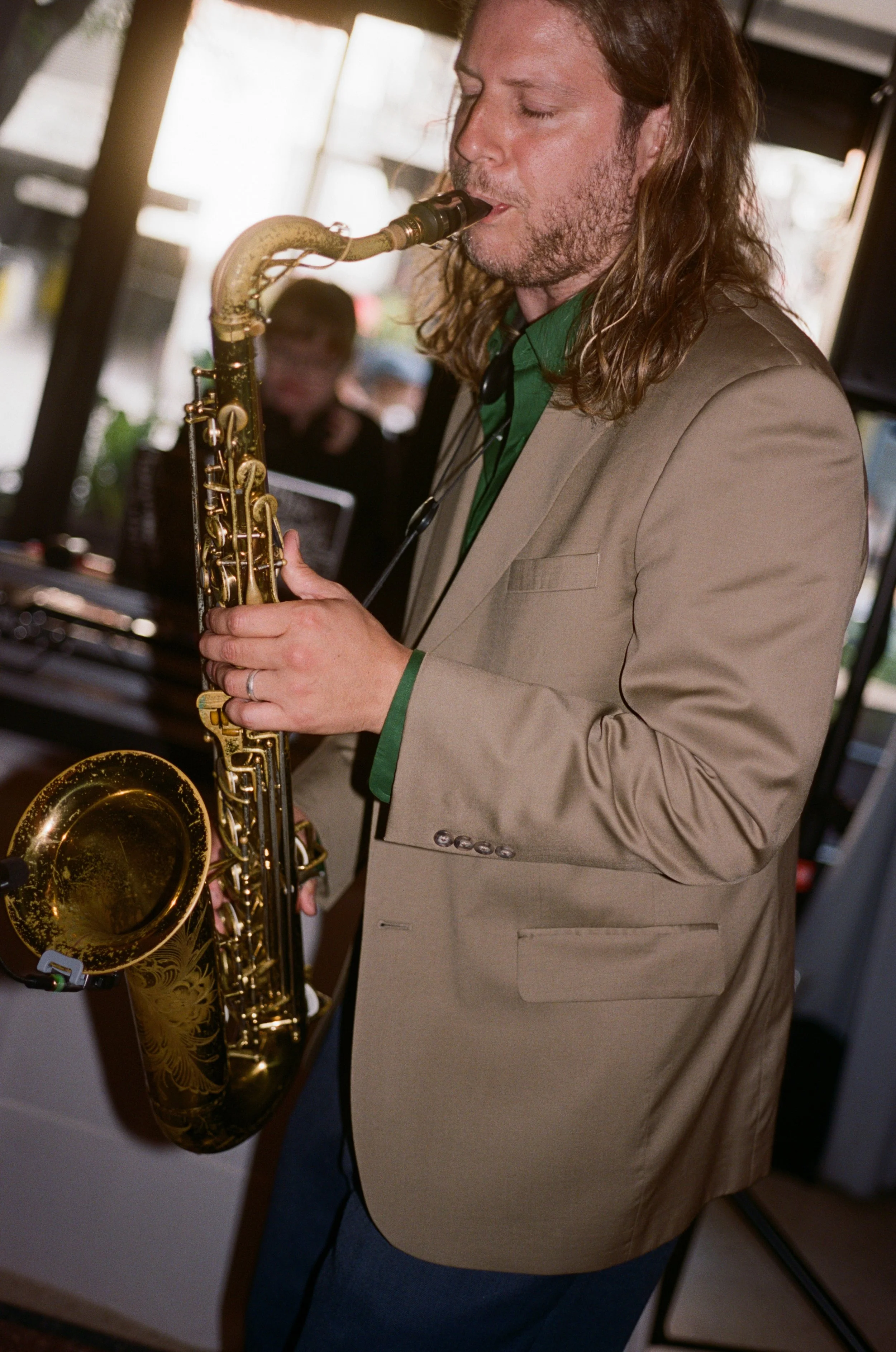 A saxophonist performs live music for guests during the reception