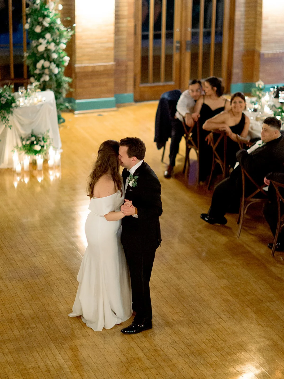 Overhead view of the couple's first dance at Cafe Brauer, wrapped in each other's arms on the gleaming hardwood floor.
