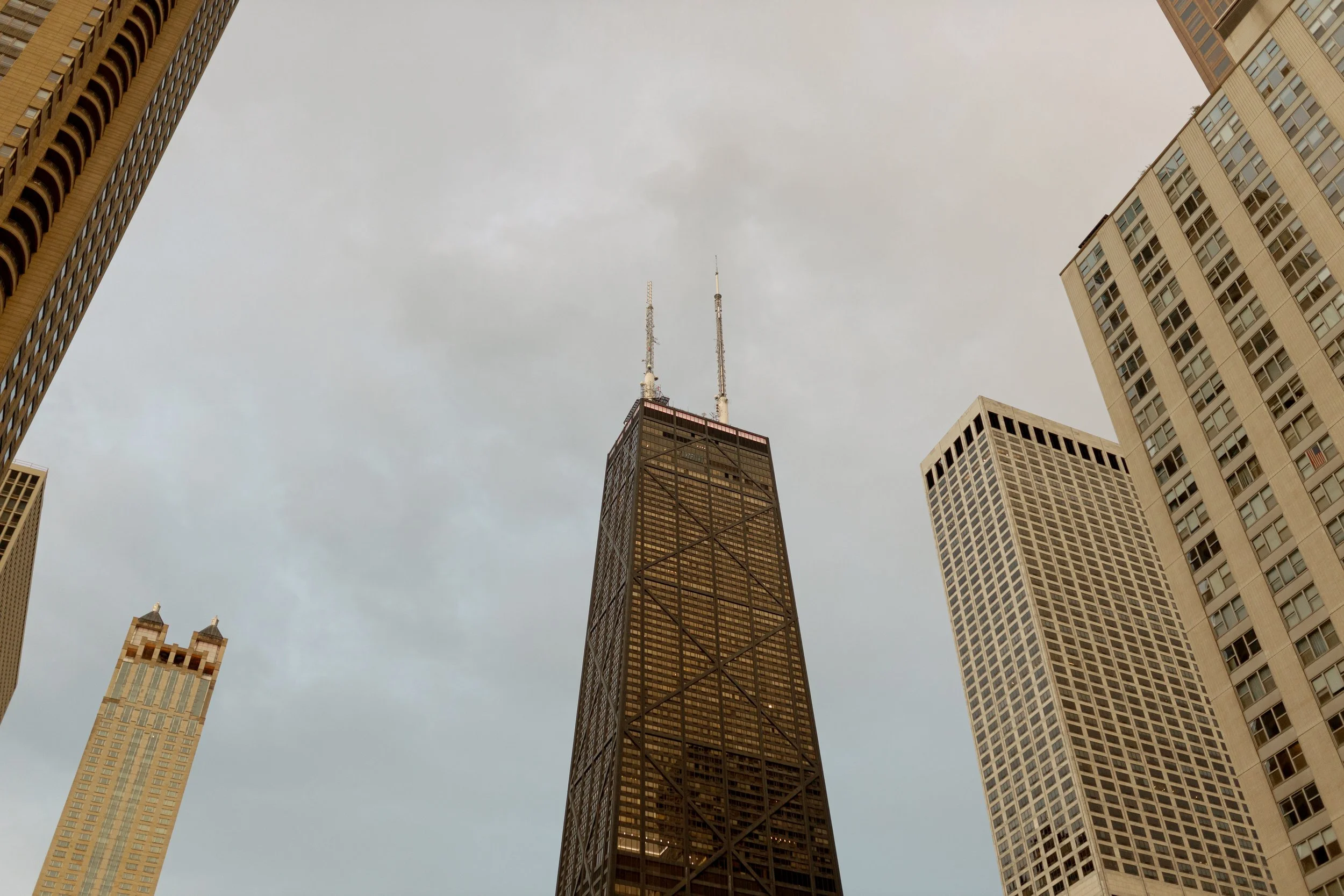 Film photograph of the John Hancock Center rising above Streeterville under a soft overcast Chicago sky