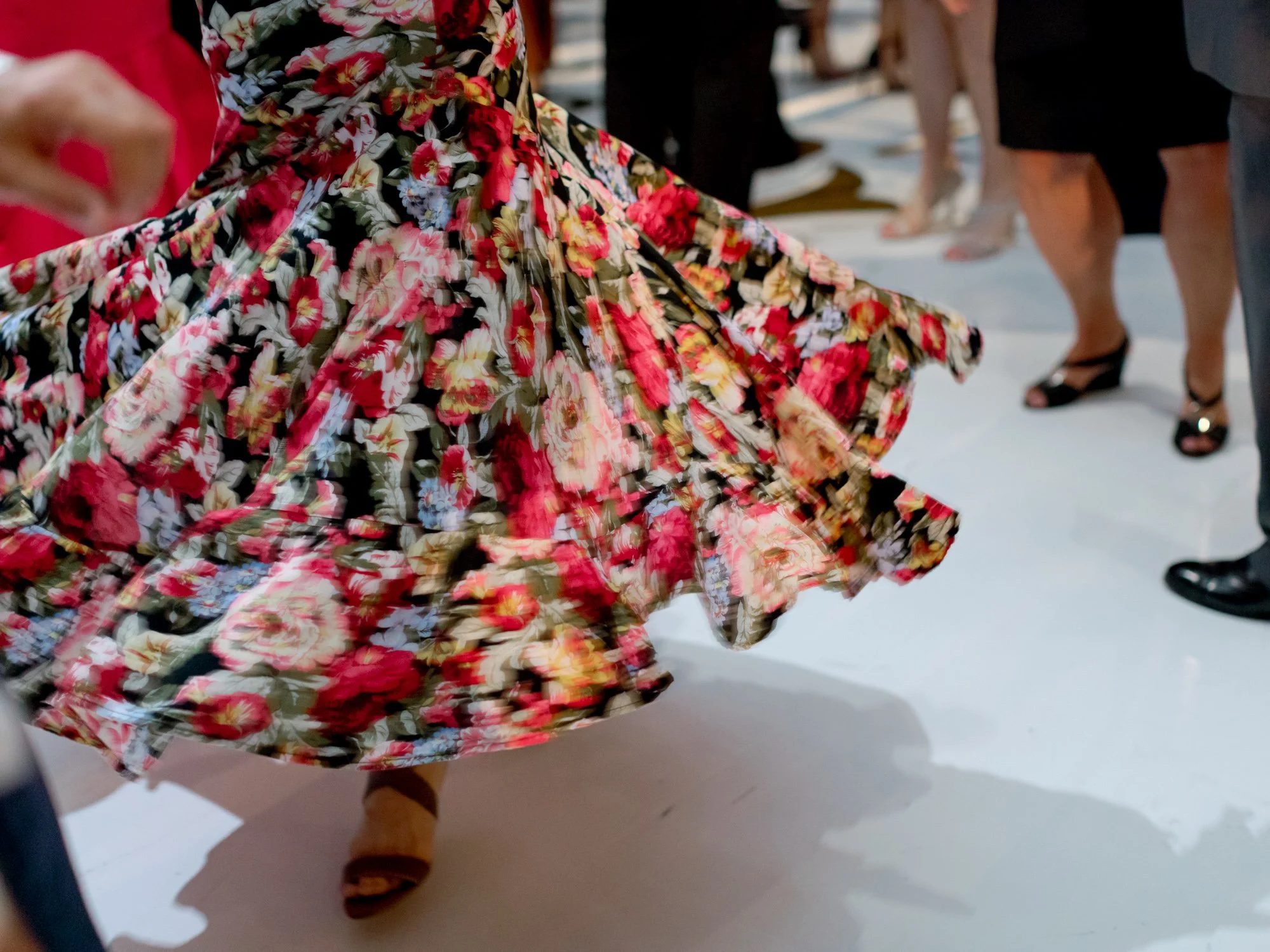 A guest’s floral print dress swirls into beautiful motion blur on the Union League Club reception dance floor — what a great live band does to a crowd.
