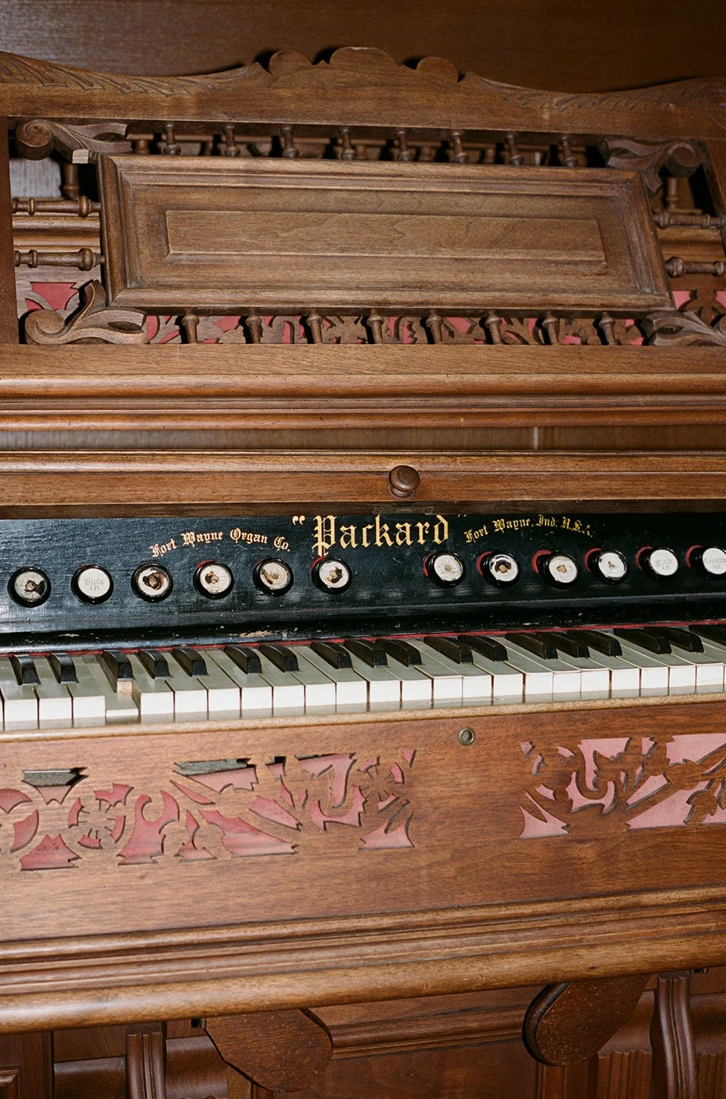 An ornately carved historic piano at the Chicago Athletic Association, a beautiful venue detail and decor element. Shot on film by a Chicago wedding photographer.