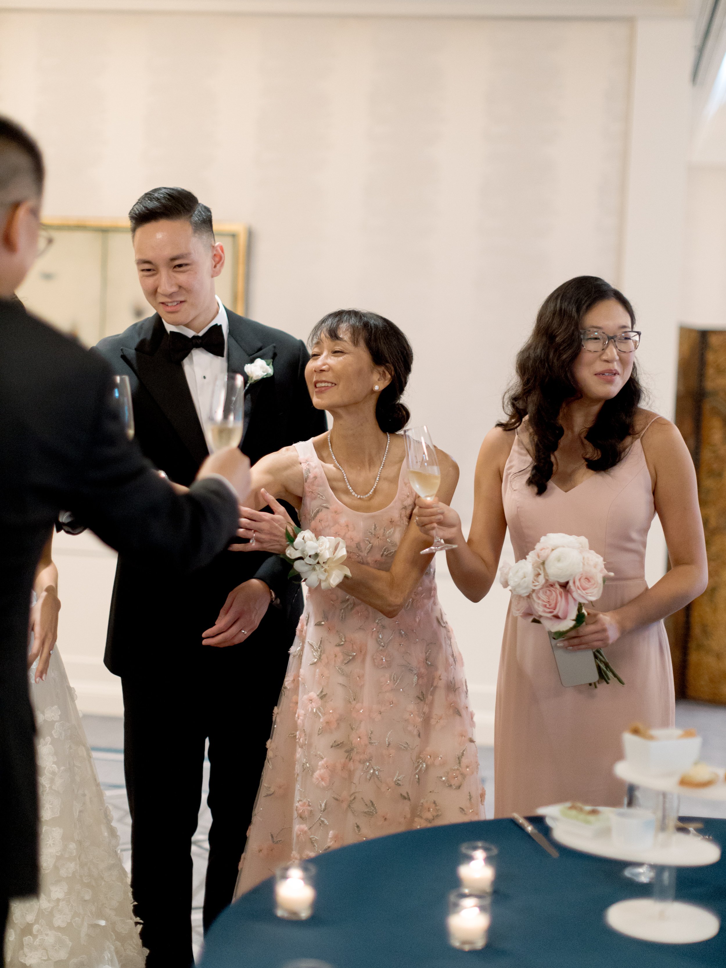 Film photograph of the brides mother wiping tears and toasting with champagne during a Peninsula Chicago wedding moment