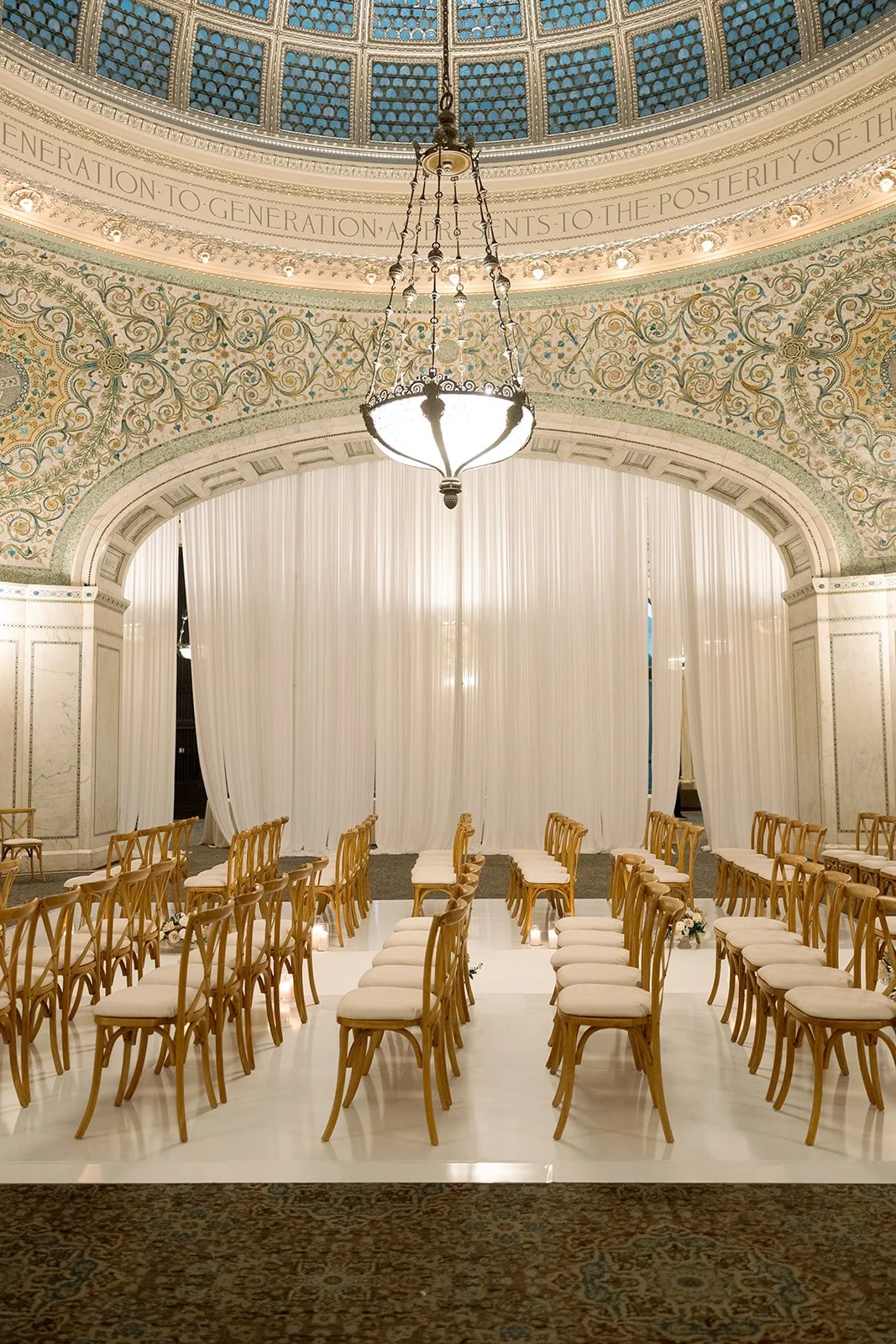 Preston Bradley Hall at Chicago Cultural Center set and ready for the ceremony, with natural light streaming through the dome. Shot on film by a Chicago wedding photographer.