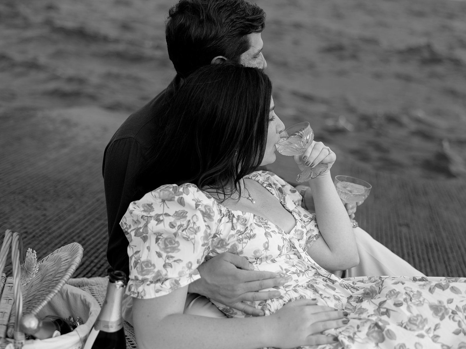 couple having a picnic with wine on lake michigan