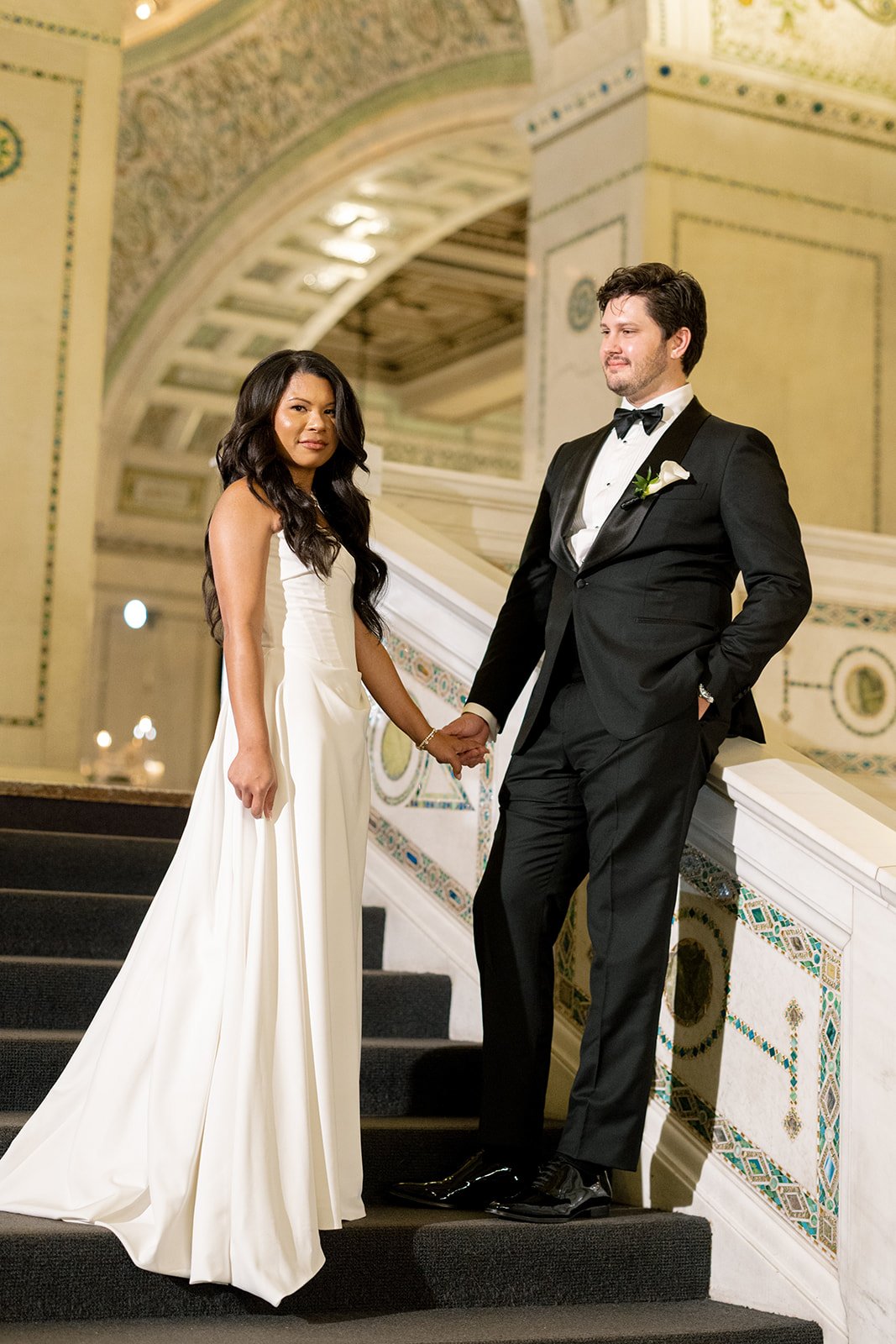 Sarah and Brennan pose together on Chicago Cultural Center's ornate marble staircase in a romantic portrait. Shot on film by a Chicago film wedding photographer.