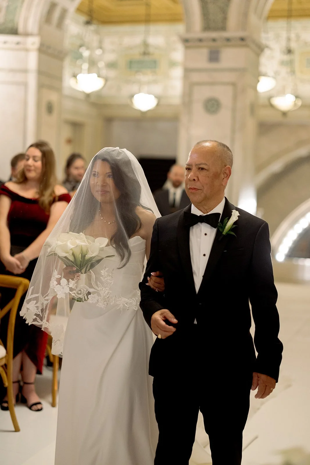 The father of the bride proudly walking his daughter down the aisle at Chicago Cultural Center. Shot on film by a Chicago film wedding photographer.