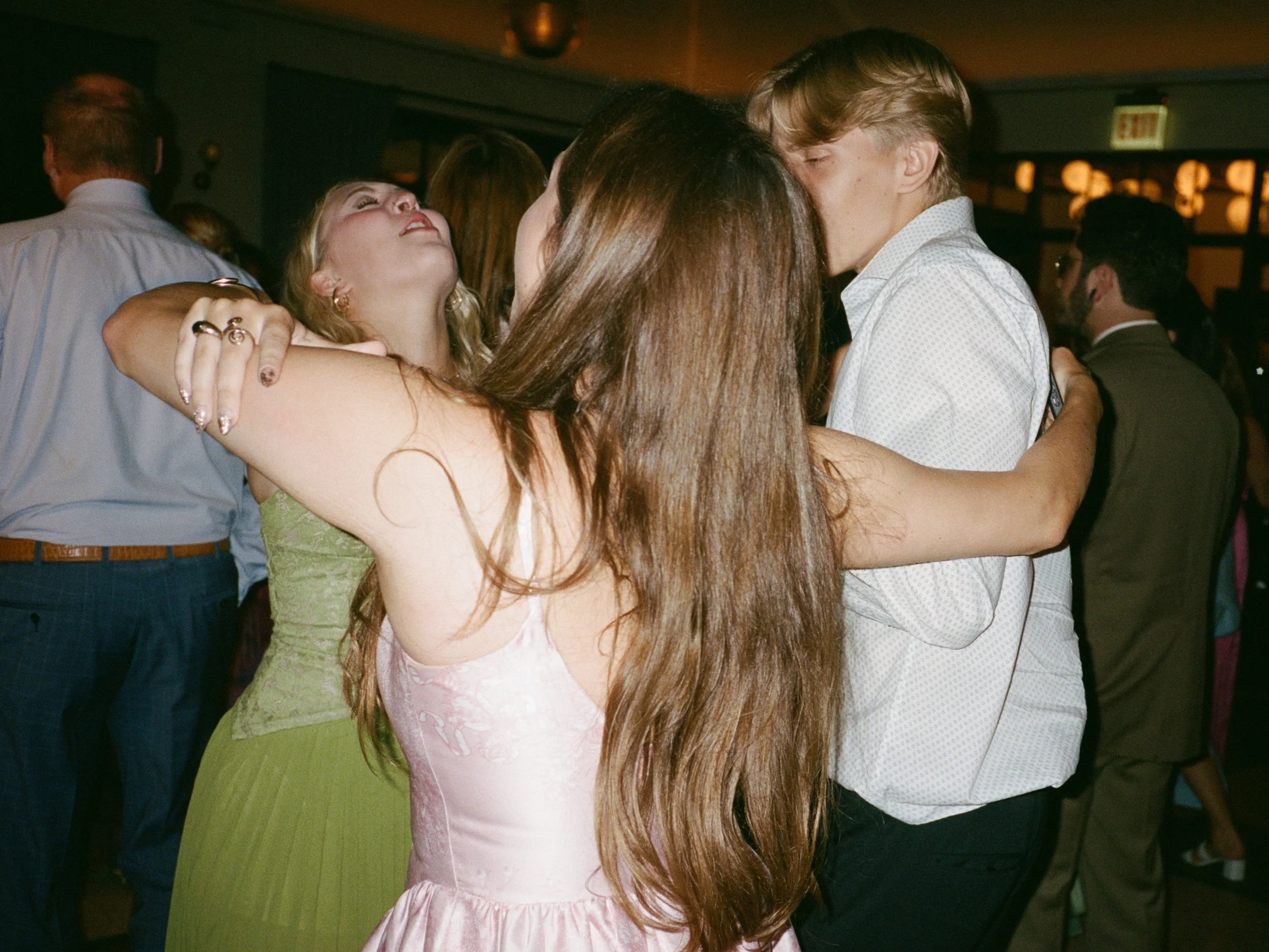 Guests dance closely together on the reception dance floor