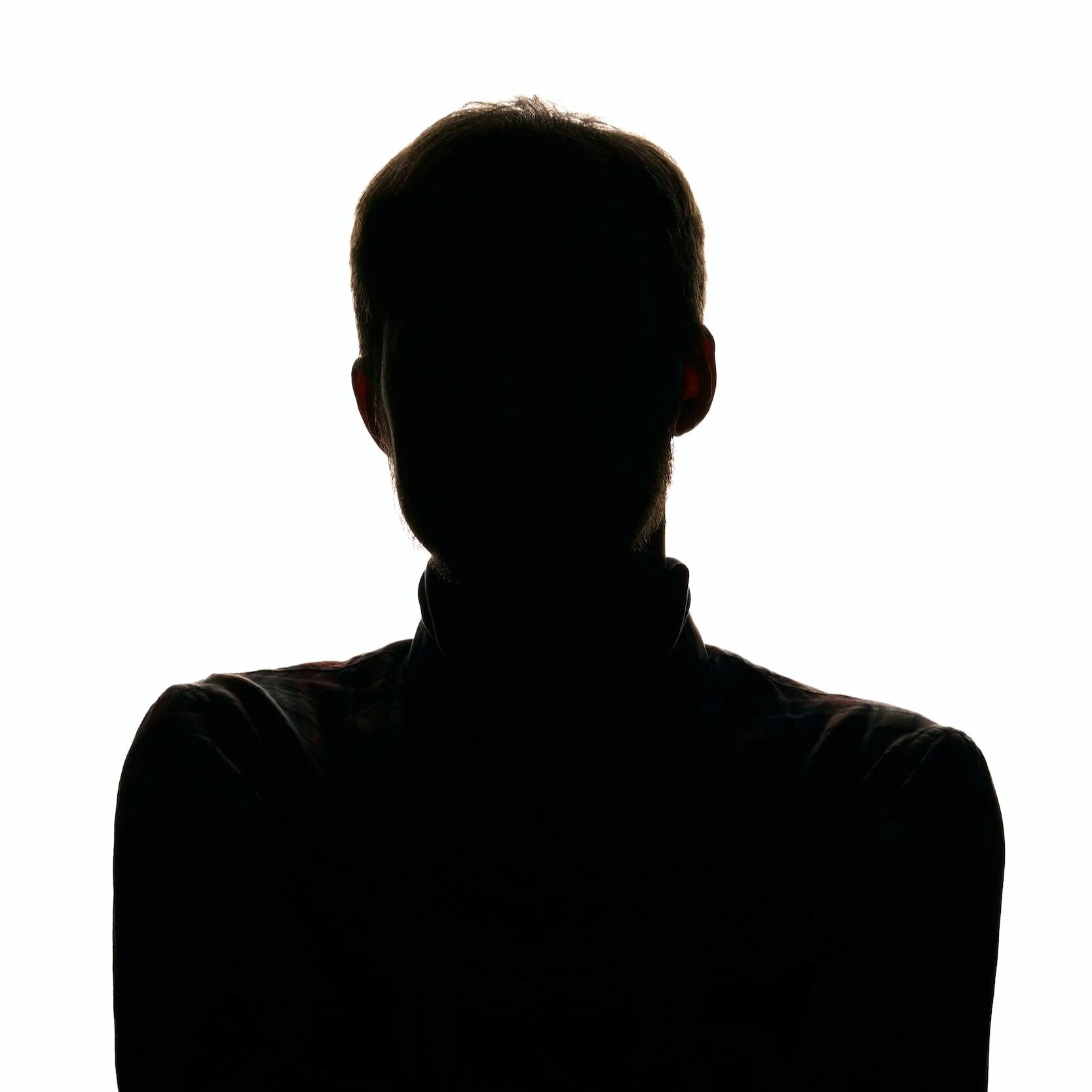 Silhouette of a person with short hair, facing forward, against a white background.