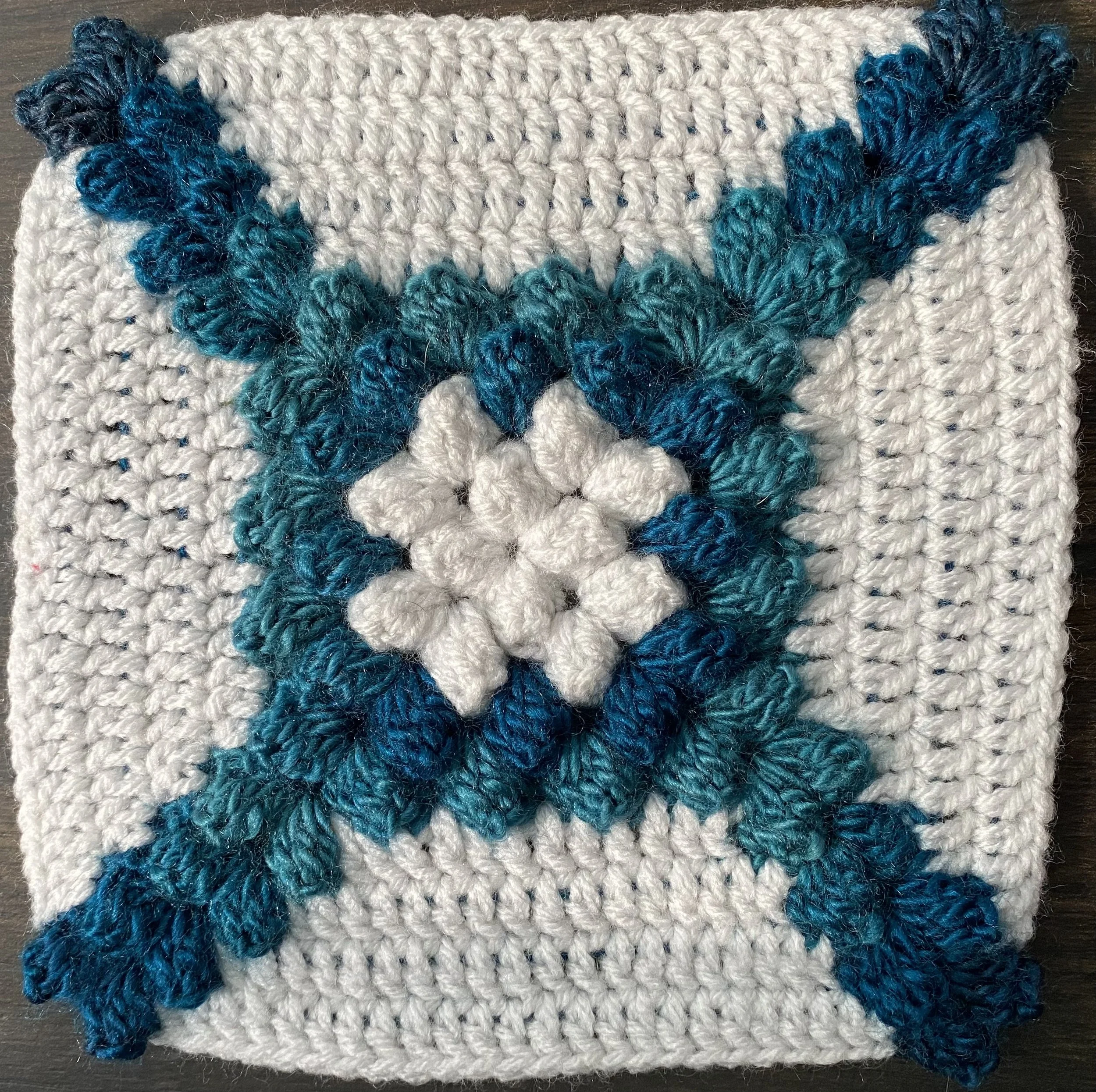 Crocheted blue cross on granny square