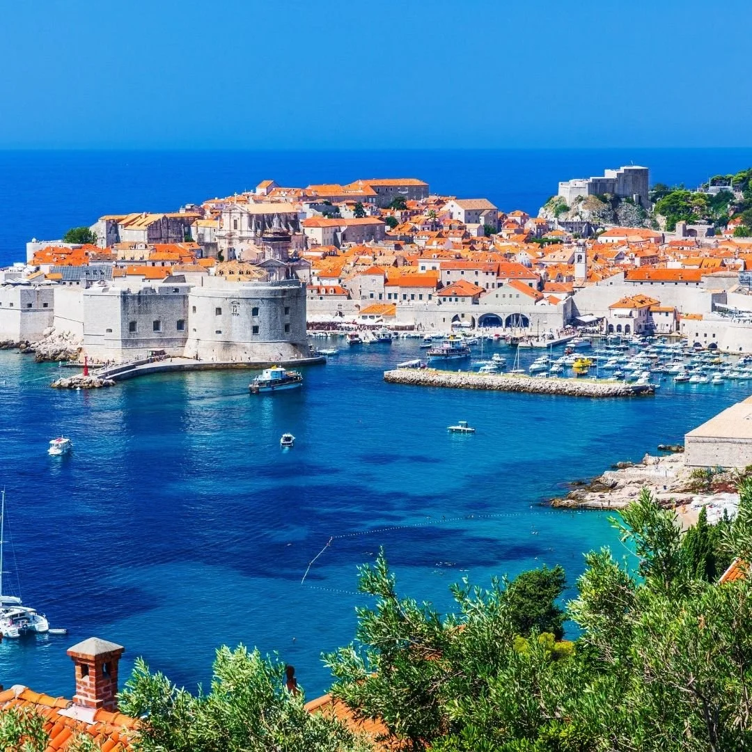 Historic walled city of Dubrovnik overlooking the Adriatic Sea, terracotta rooftops and calm blue harbour