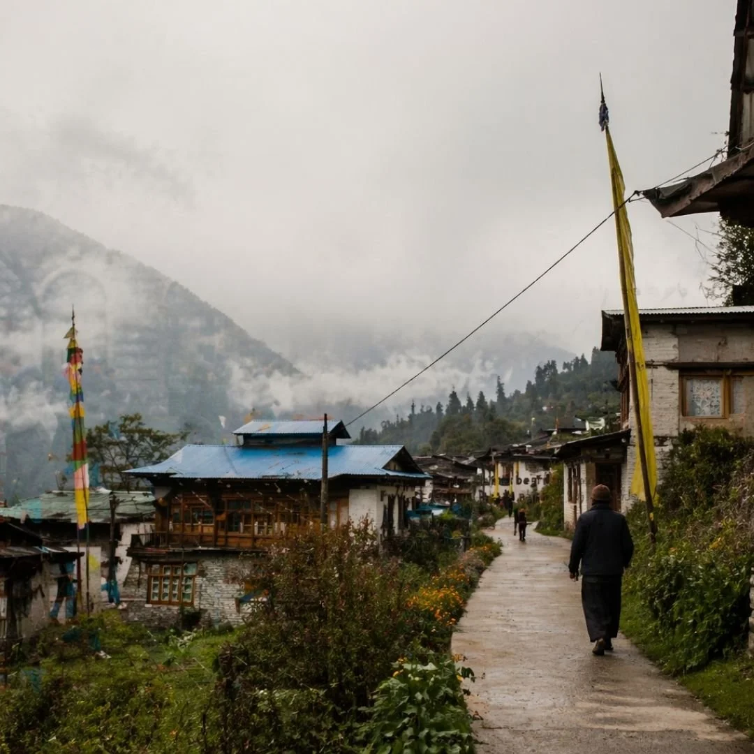 Traditional homestay in Dirang Arunachal Pradesh overlooking a misty valley with soft natural light