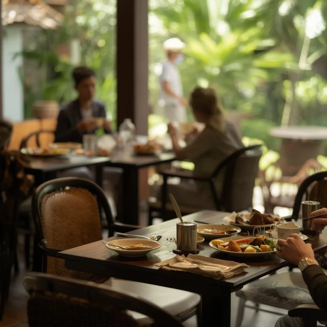 Casual meal on a table in a Bali café setting with soft natural light and greenery in the background