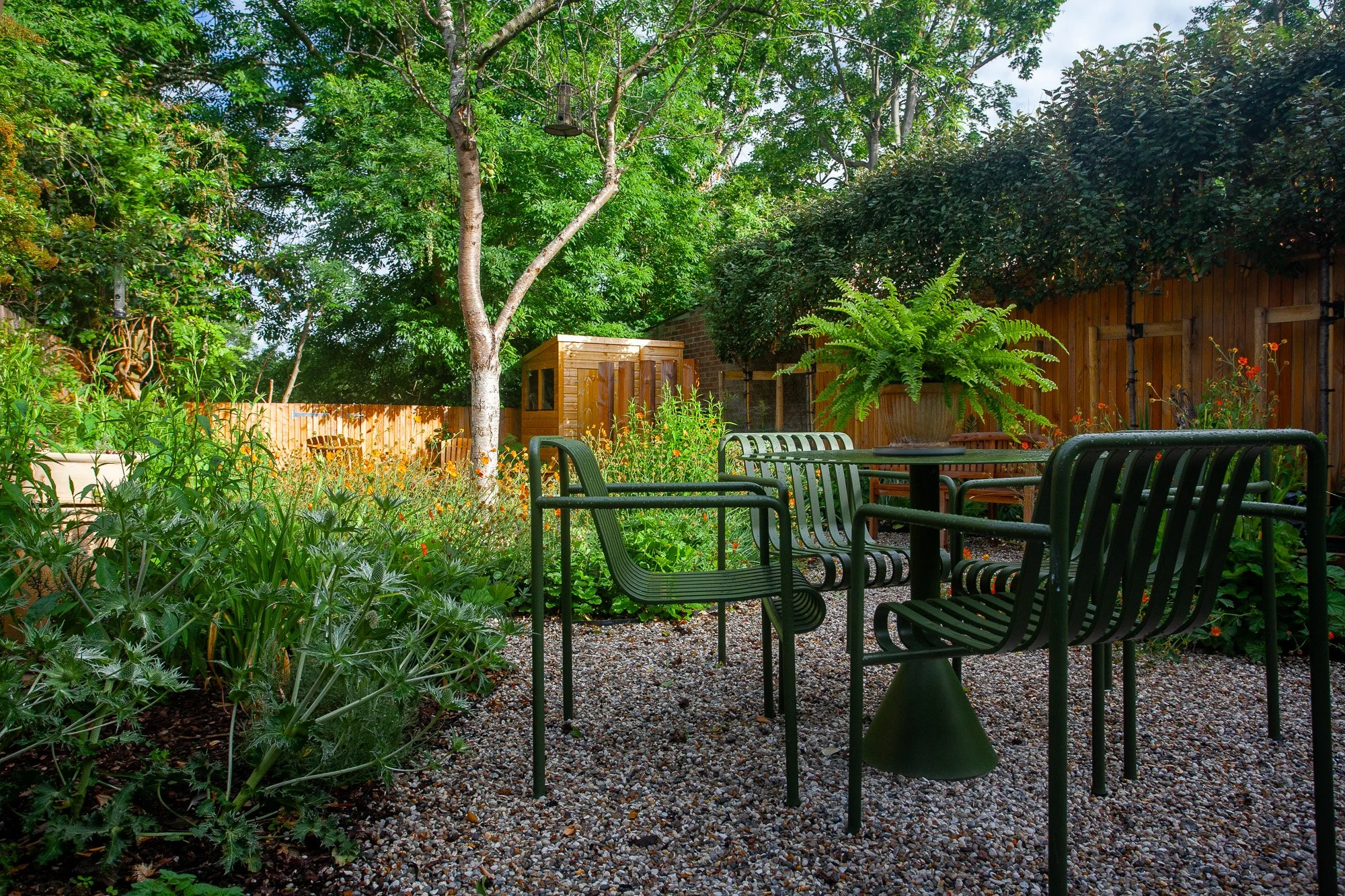 catriona-rowbotham-garden-design-green-chairs-gravel-biodiversity-planting-shed.jpg.jpg
