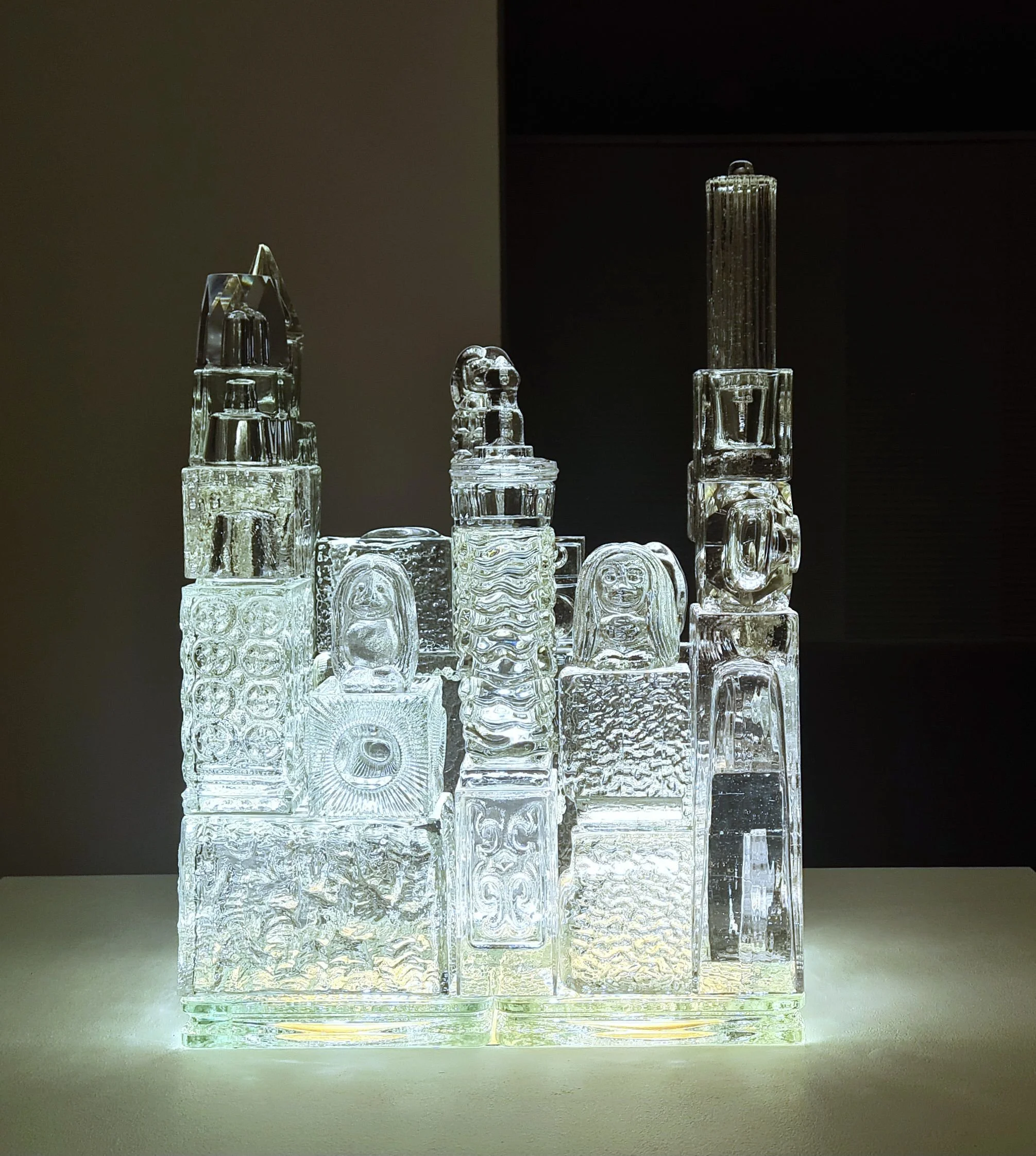 "The Kingdom of Crystal", 2025. Glass objects, podium, light. 85 x 90 x 62 cm