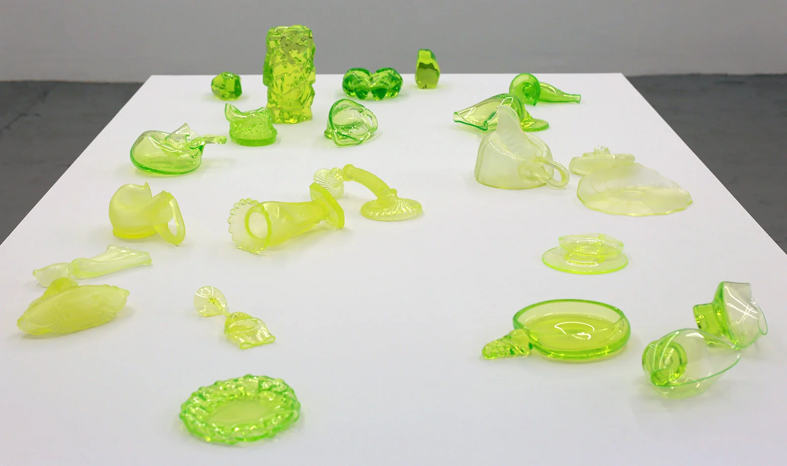 "The Melting Down", 2017 - 18.
Uranium glass (modified found objects)
Dim. var. (55 x 210 x 120 cm)