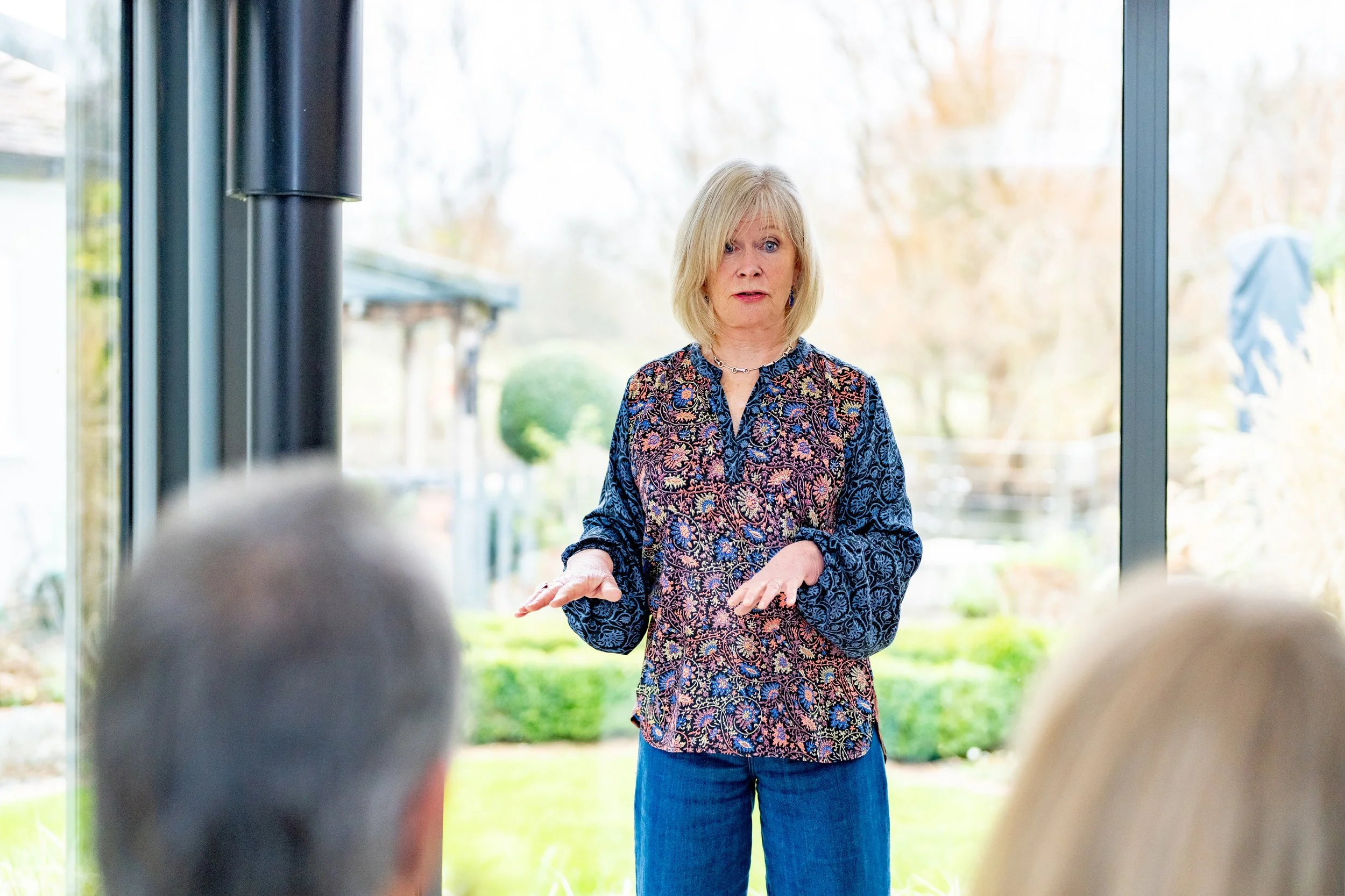 Heartwood Stories owner gestures as she presents to clients