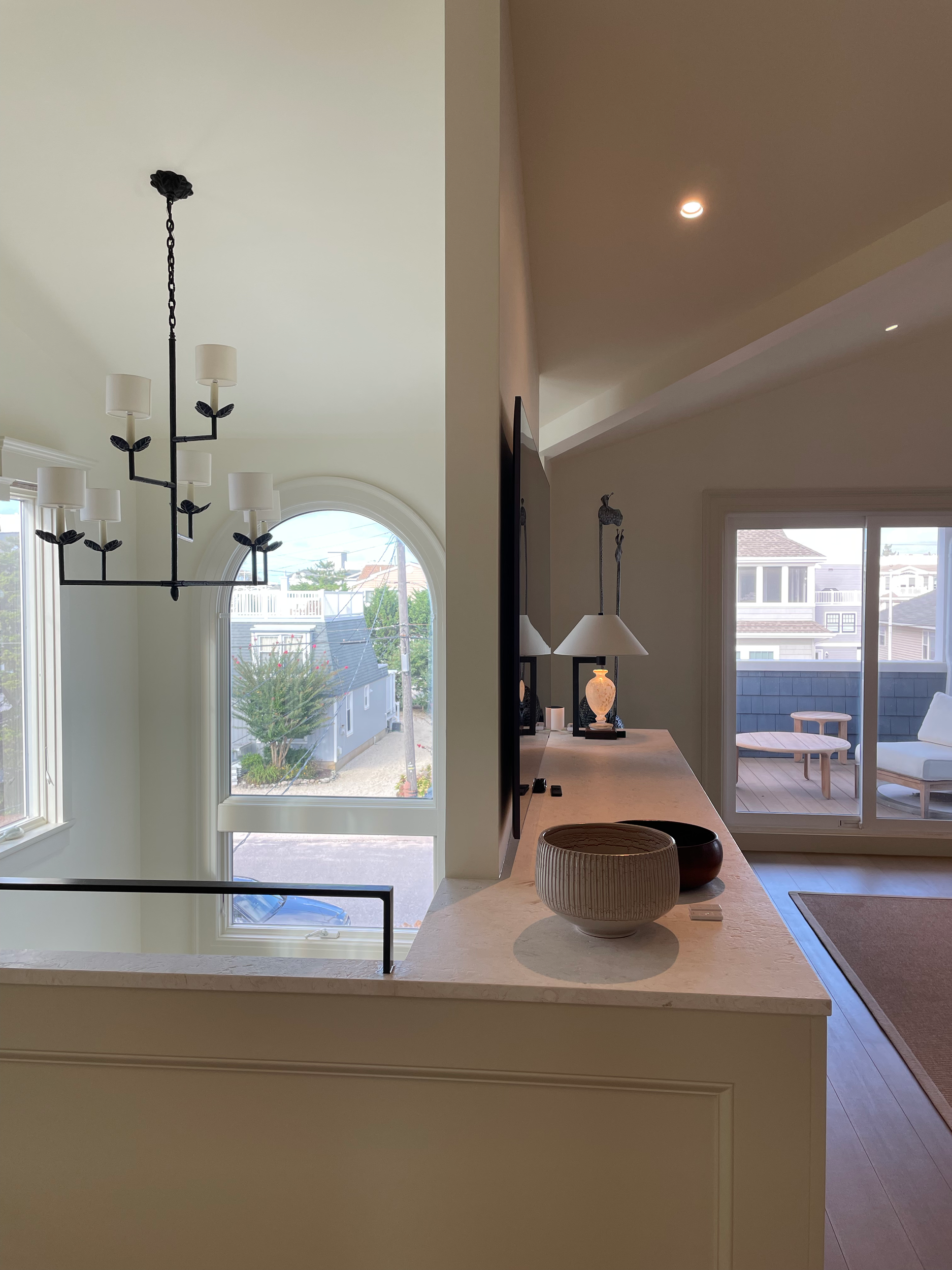 At the top of the stairs in this LBI beach house.  I love the rhythm happening with the angles in the chandelier, table lamp and handrail.