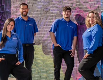 A group photo of four Blue Eagle team members smiling.