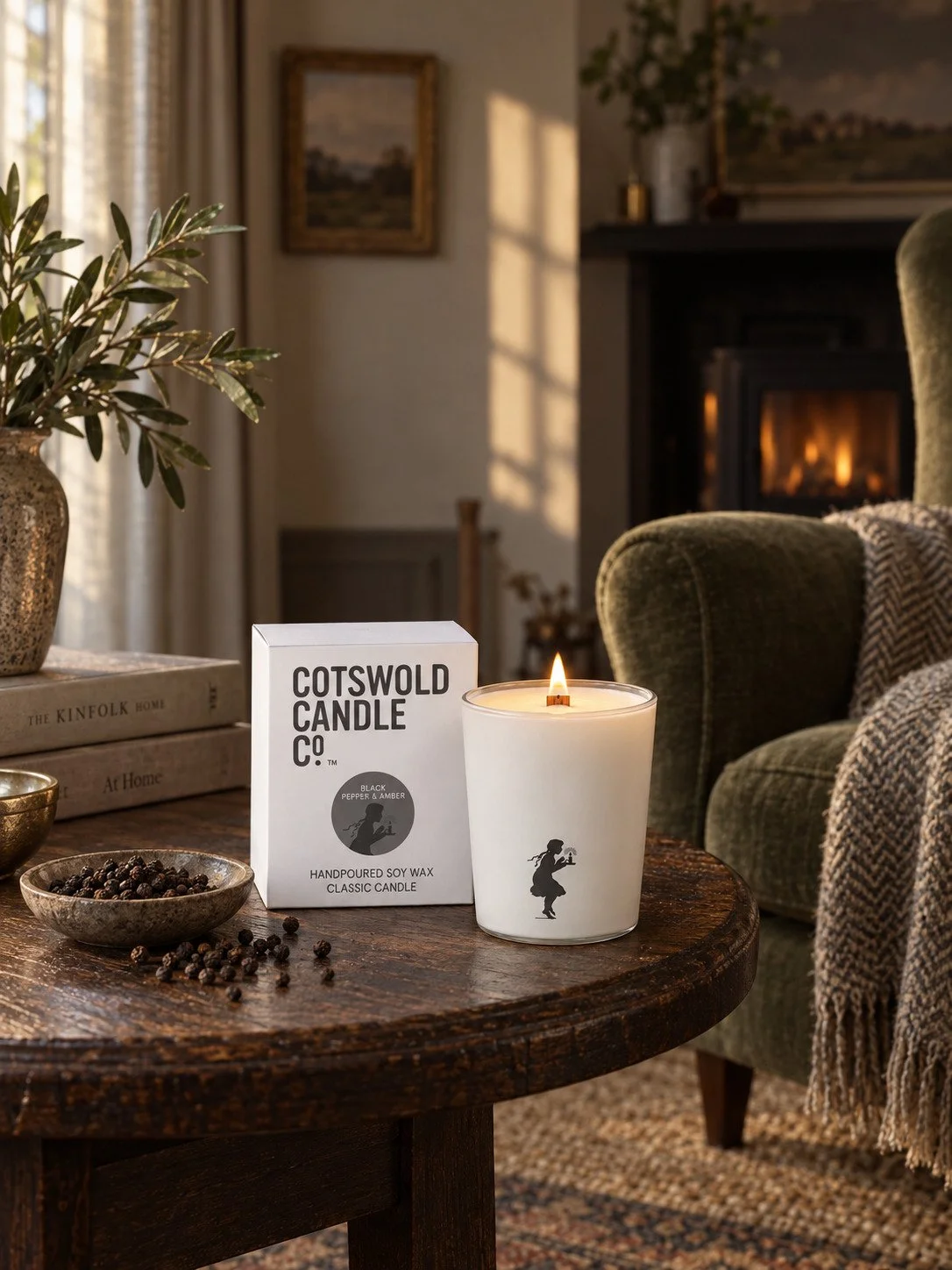 Black Pepper & Amber wood wick candle and matching box by Cotswold Candle Co., styled in a home interior with natural light.