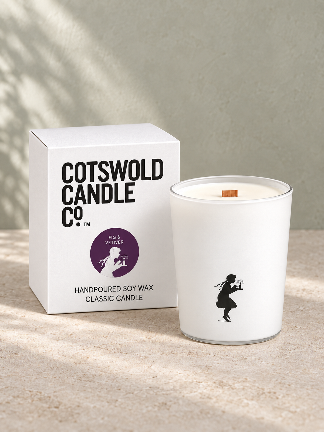 Cotswold Candle Co. wood wick candle in a white glass jar beside its matching white box.