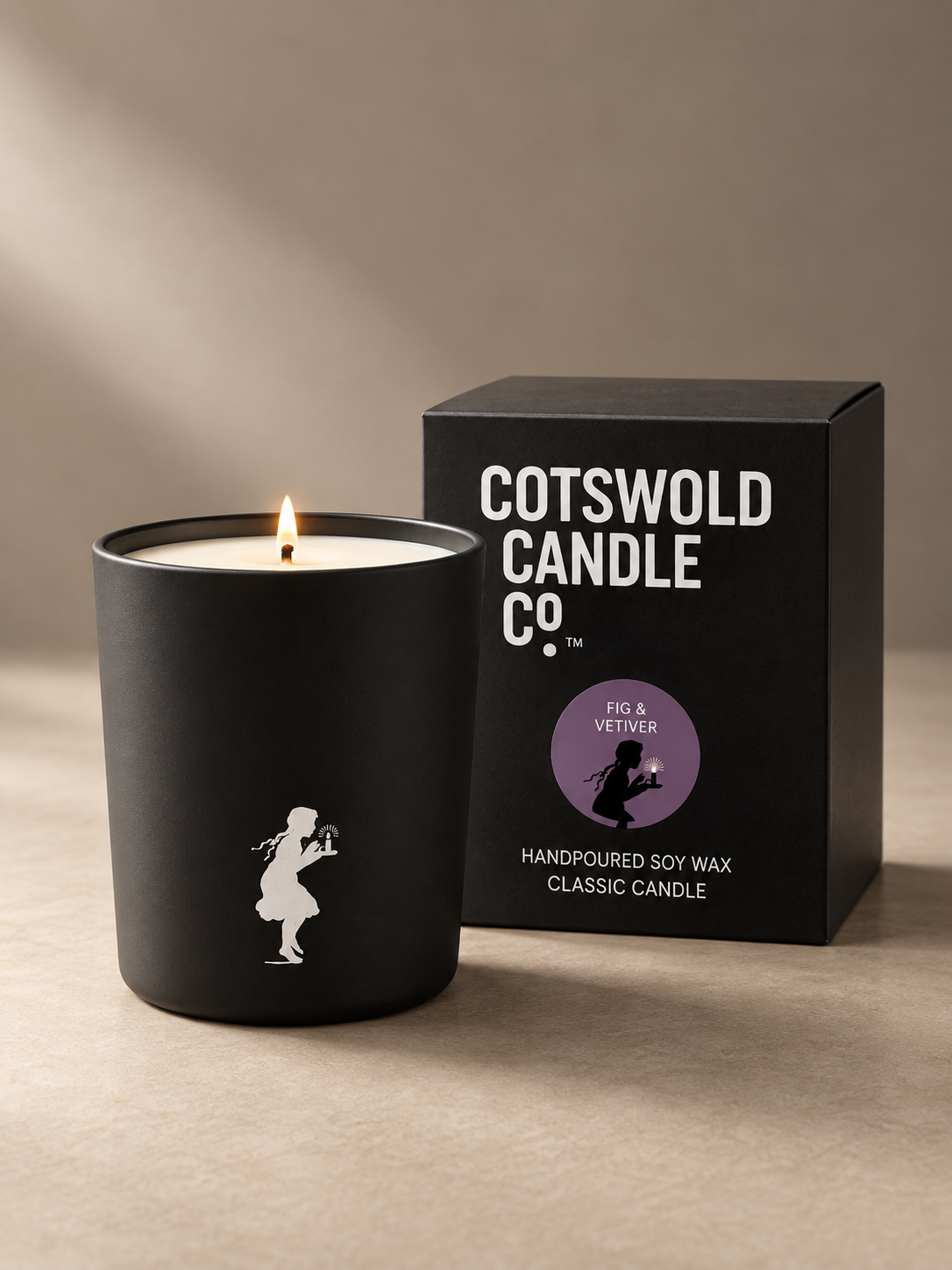 Cotswold Candle Co. cotton wick candle in a black glass jar beside its matching black box.