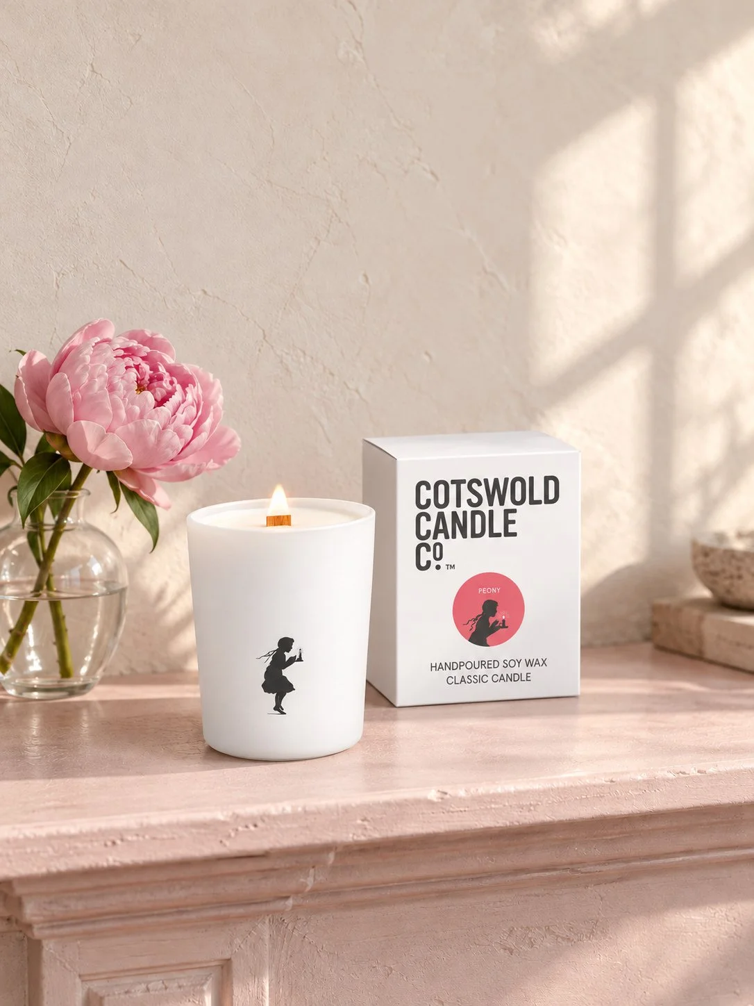 Peony wood wick candle and matching box by Cotswold Candle Co., styled in a home interior with natural light.