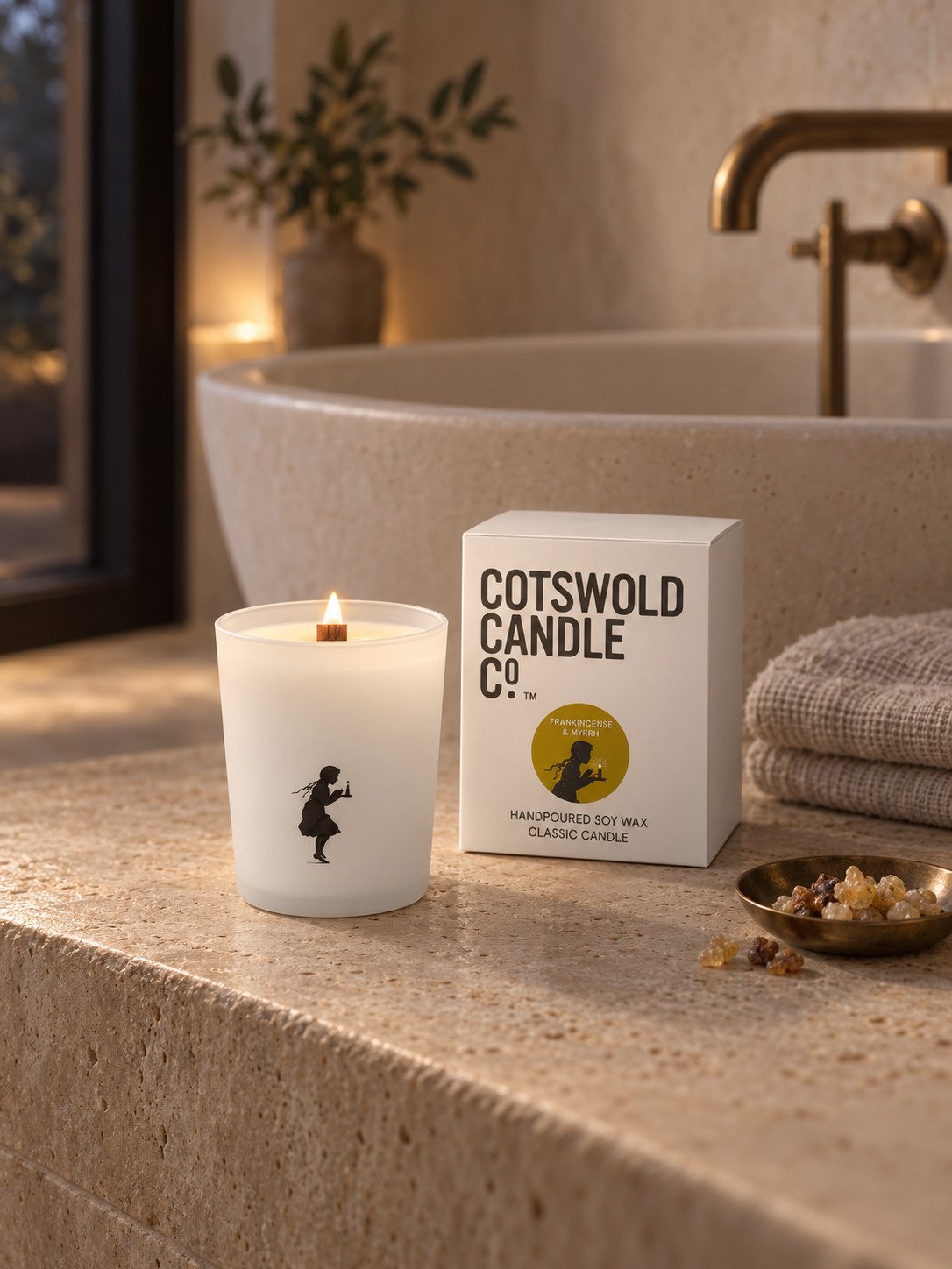 Frankincense & Myrrh wood wick candle and matching box by Cotswold Candle Co., styled in a home interior with natural light.