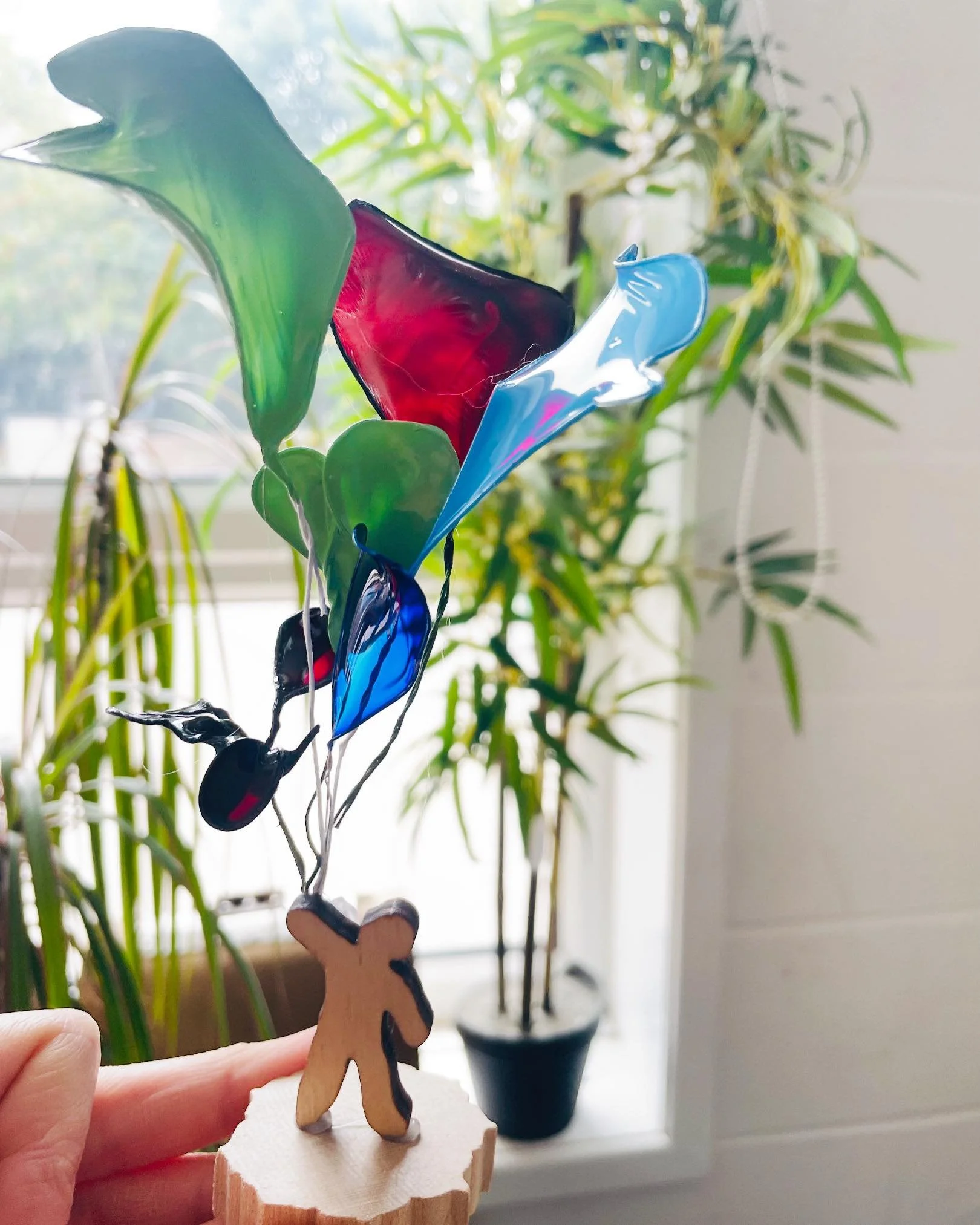 Person holding balloons, made in our afterschool club