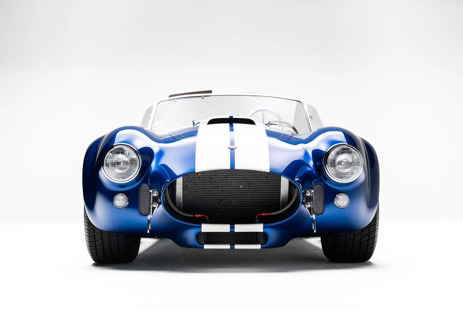 Superformance MKIII in blue metallic with white stripes, front view