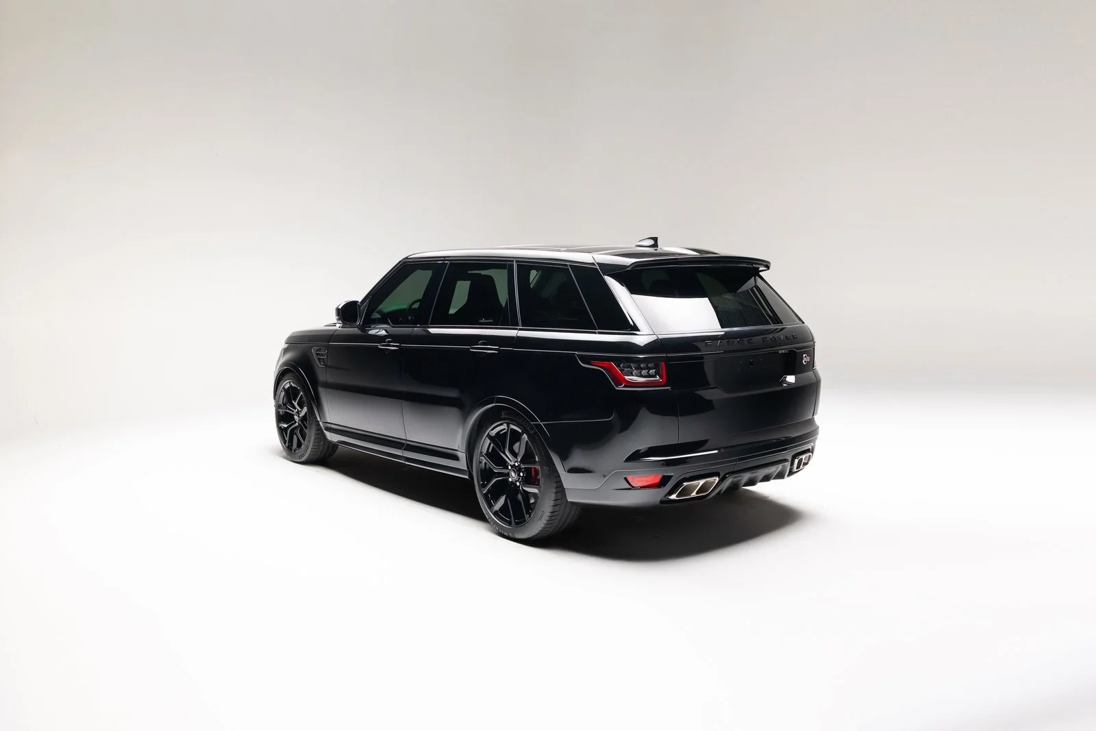 Rear three-quarter studio view of the black 2022 Range Rover Sport SVR.