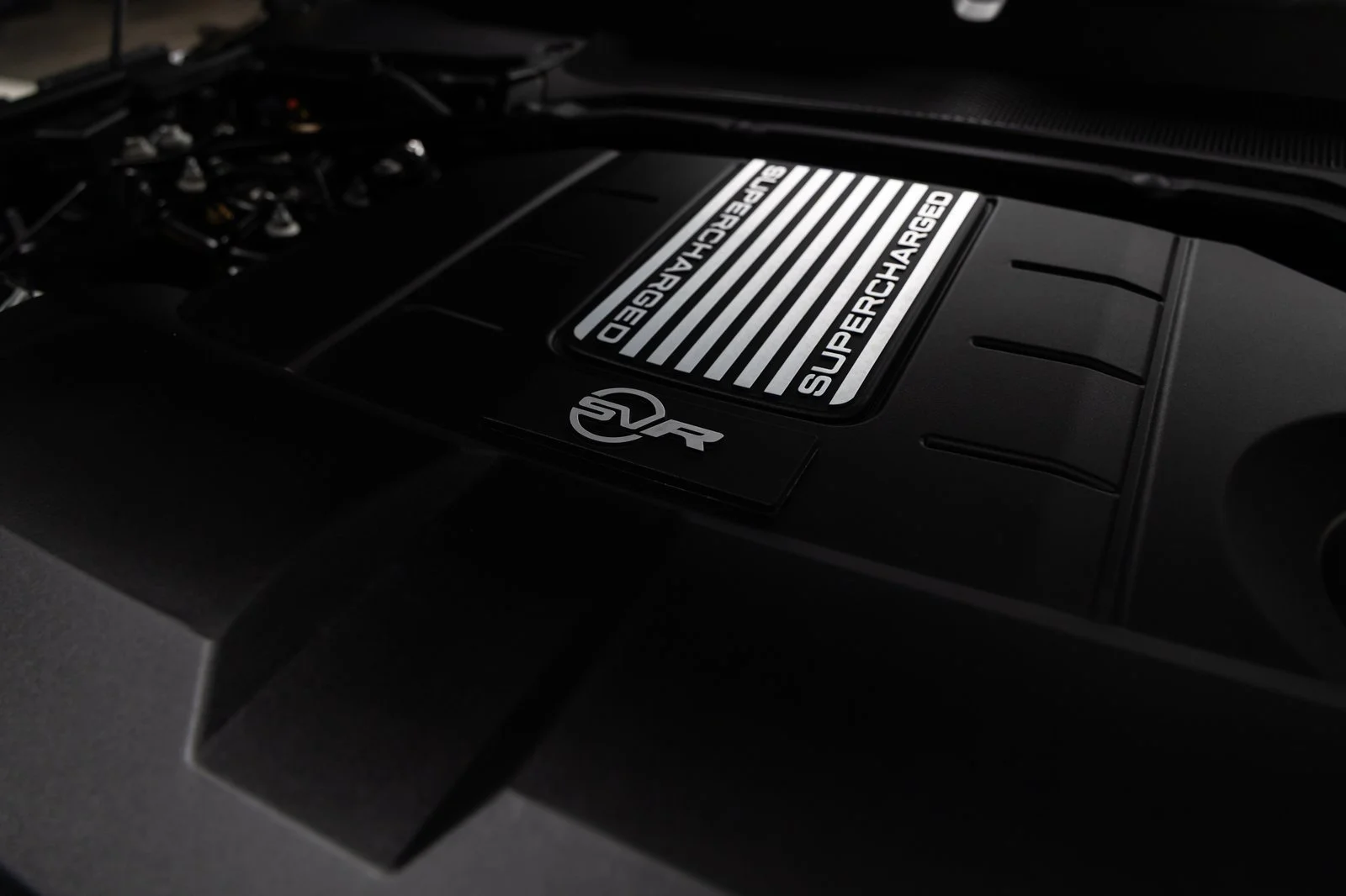 Close-up of the supercharged V8 engine cover with SVR branding in the 2022 Range Rover Sport SVR.