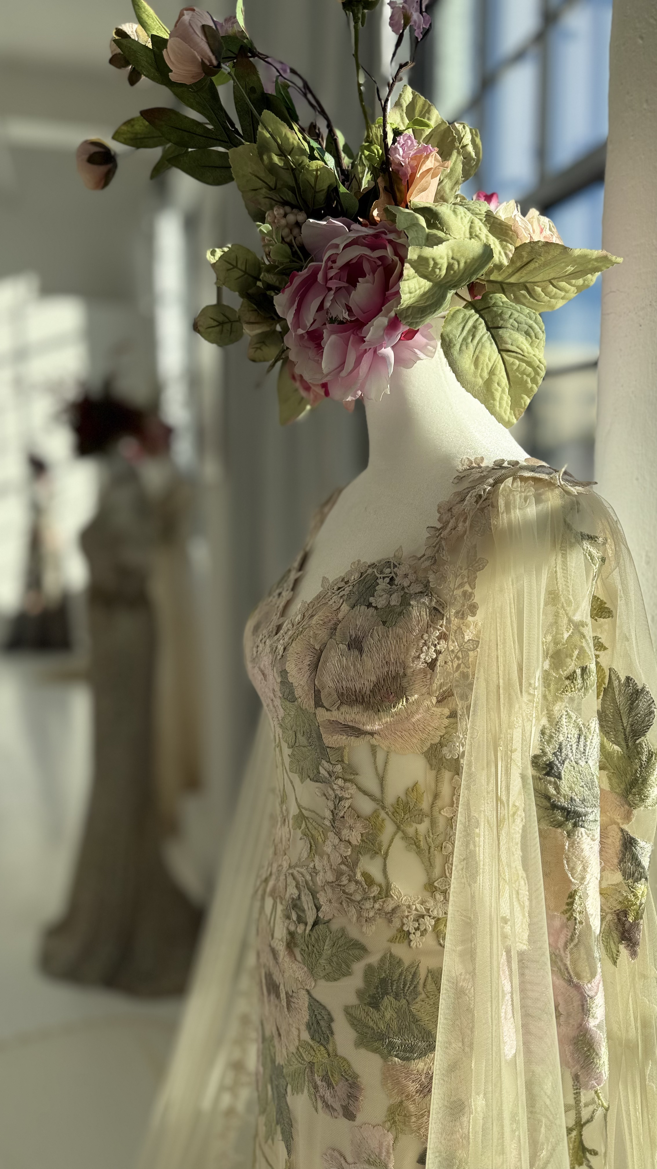 Close-up of a designer ivory tulle wedding gown on a dress form at Daylight Studio's NYC bridal showroom venue.