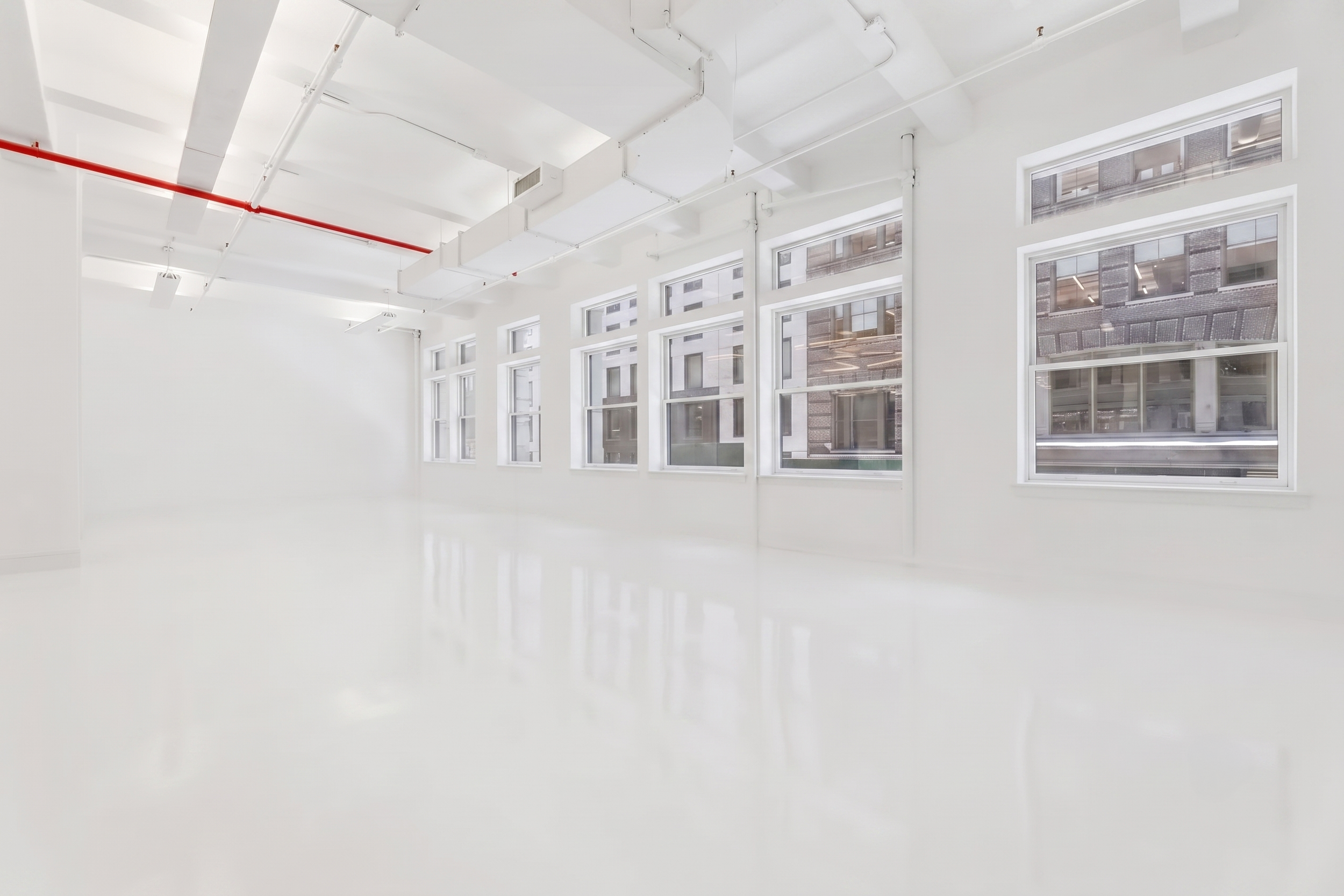 2,000 SF Flatiron Studio NYC, 50 W 17th Street, large windows, natural daylight, white epoxy floors, 14' ceiling, blackout capable, fashion and commercial photo studio rental Flatiron District New York.