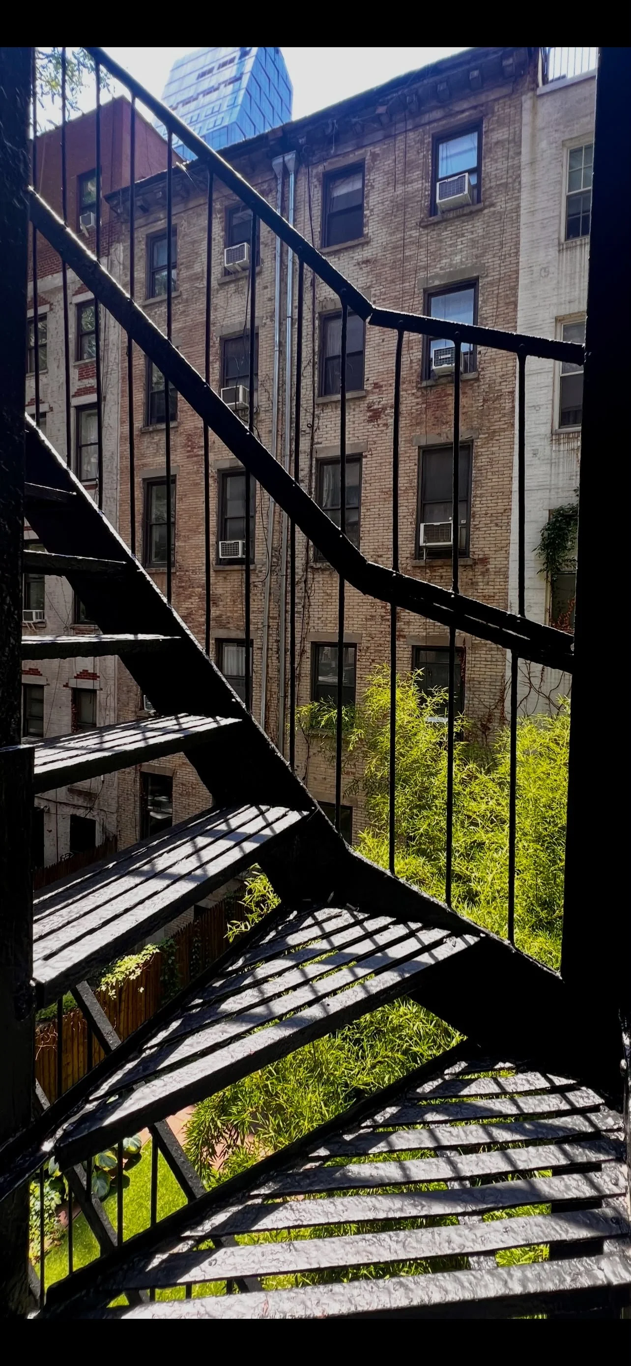 Metal fire escape stairs against brick building, urban loft exterior