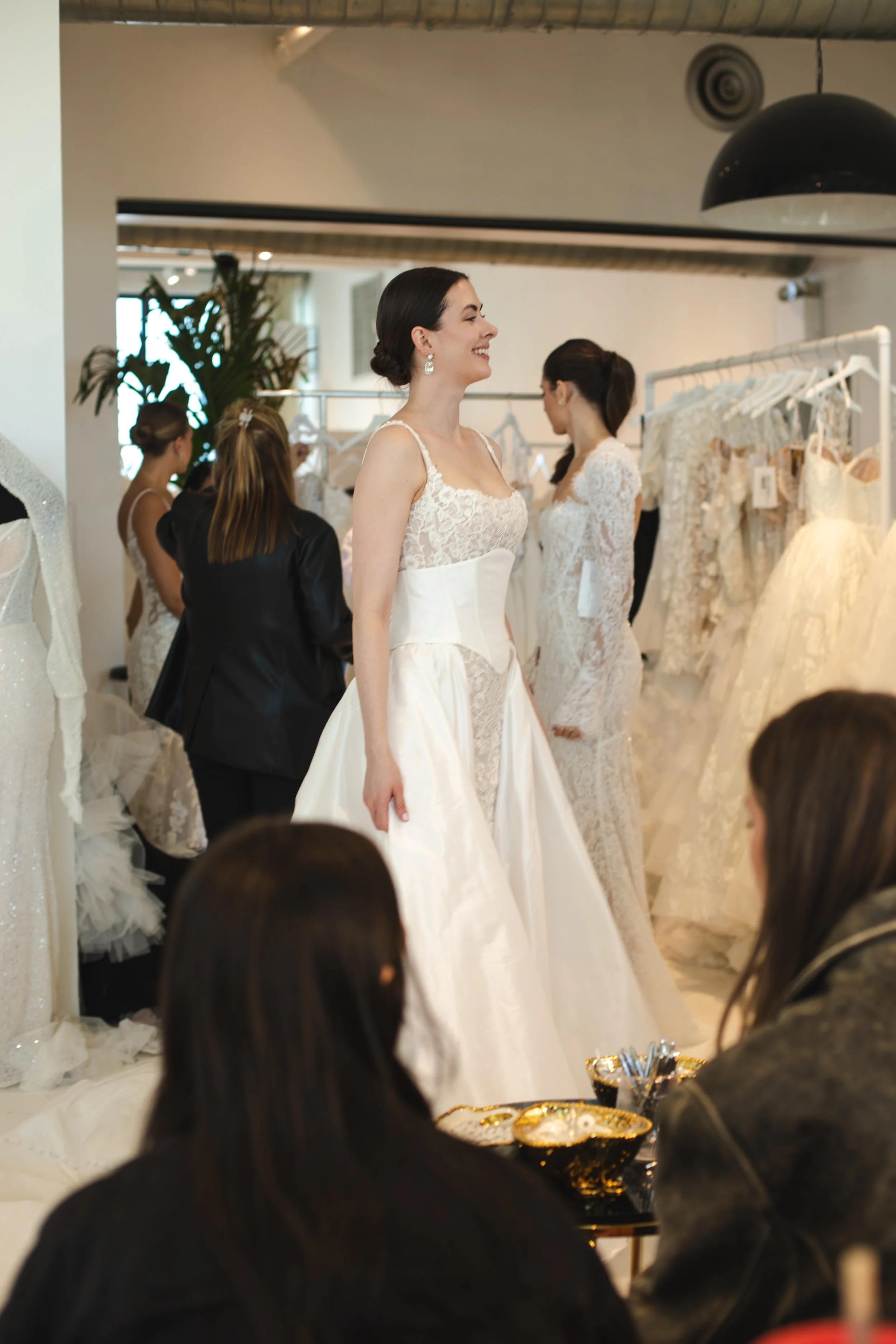 Bride in a lace ball gown wedding dress inside a custom-configured bridal fitting room and showroom venue at Daylight Studio NYC.