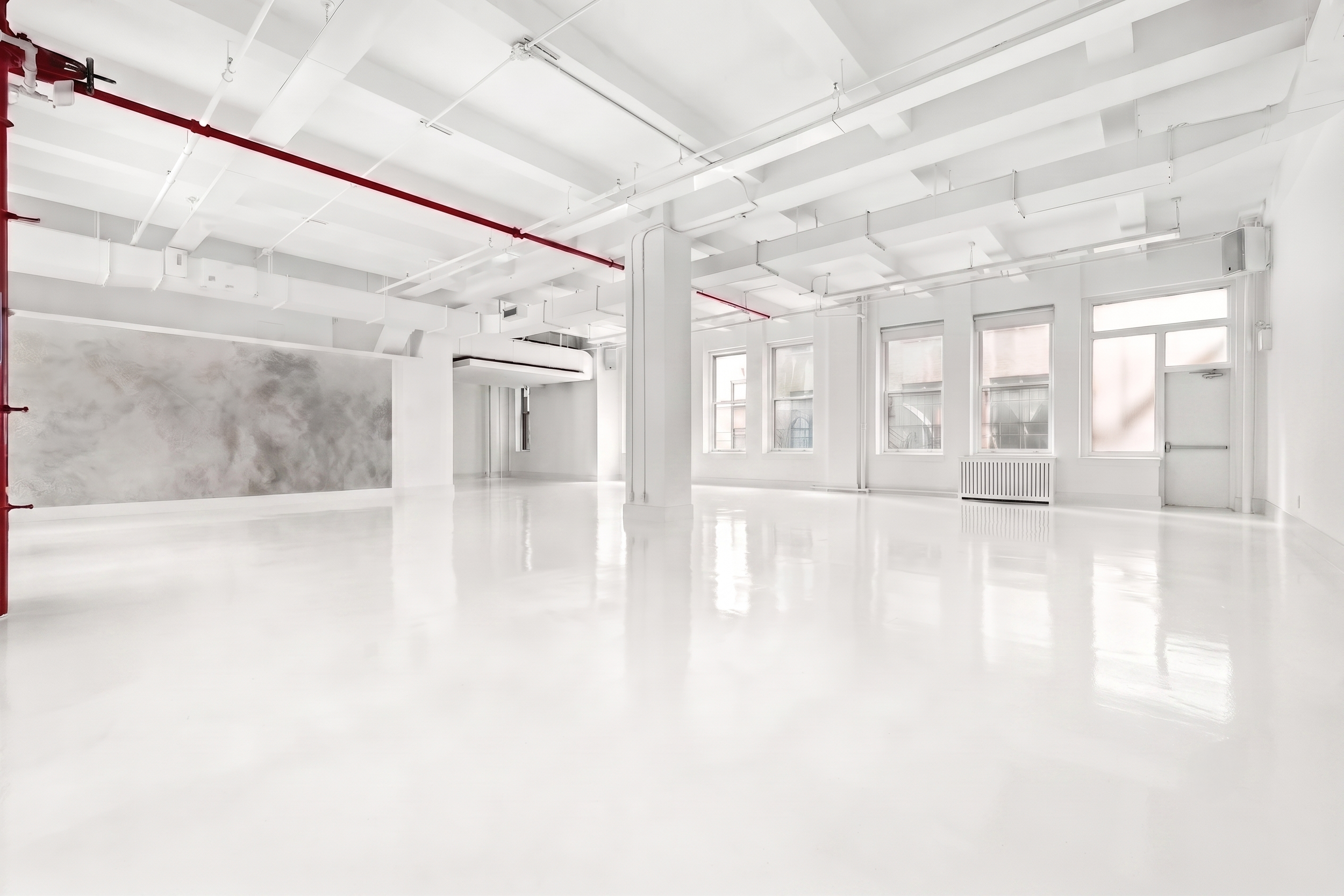 Wide white studio space with red pipe, gray abstract wall panel, glossy floor