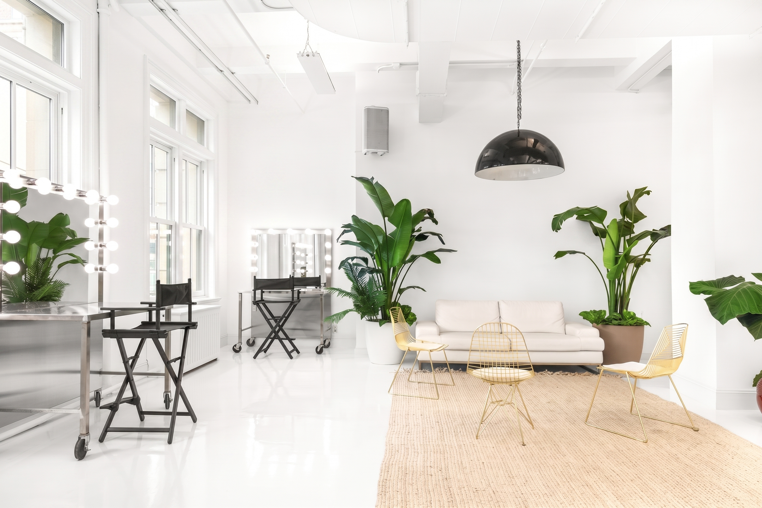 6,000 SF Flatiron Studio NYC, 50 W 17th Street, natural daylight, white epoxy floors, lounge area, hair and makeup stations, director's chairs, fashion and brand campaign studio rental Flatiron District New York.