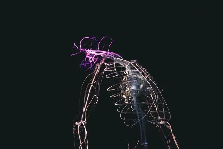 Artistic display of a light sculpture resembling a human figure with glowing purple hair and a transparent body outline.