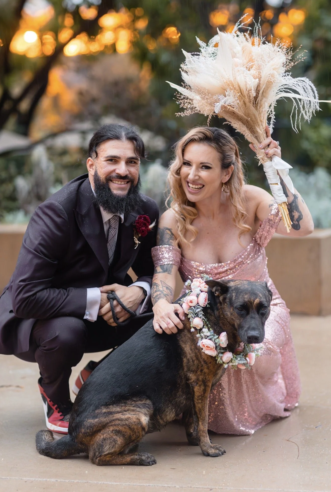 a bride and groom with their dog at their UCLA wedding