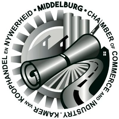 A circular logo with a megaphone in the center, surrounded by a gear, a road, and a building. The text around the logo reads 'KAMER KOOPHANDEL EN VRIENDEN - NIJMEGEN - MIJDENBURG - CHAMERA - CHAMBER OF COMMERCE AND INDUSTRY'.