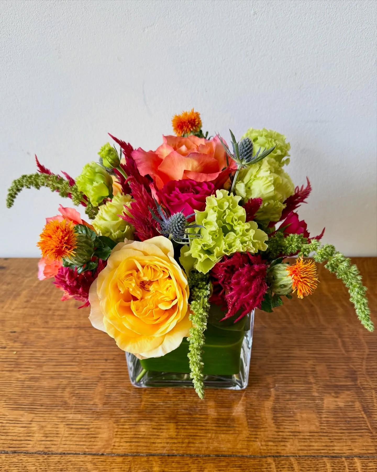 We are loving this summer-into-fall floral arrangement, featuring roses, thistle, local frilly green lisianthus, pink celosia and more!