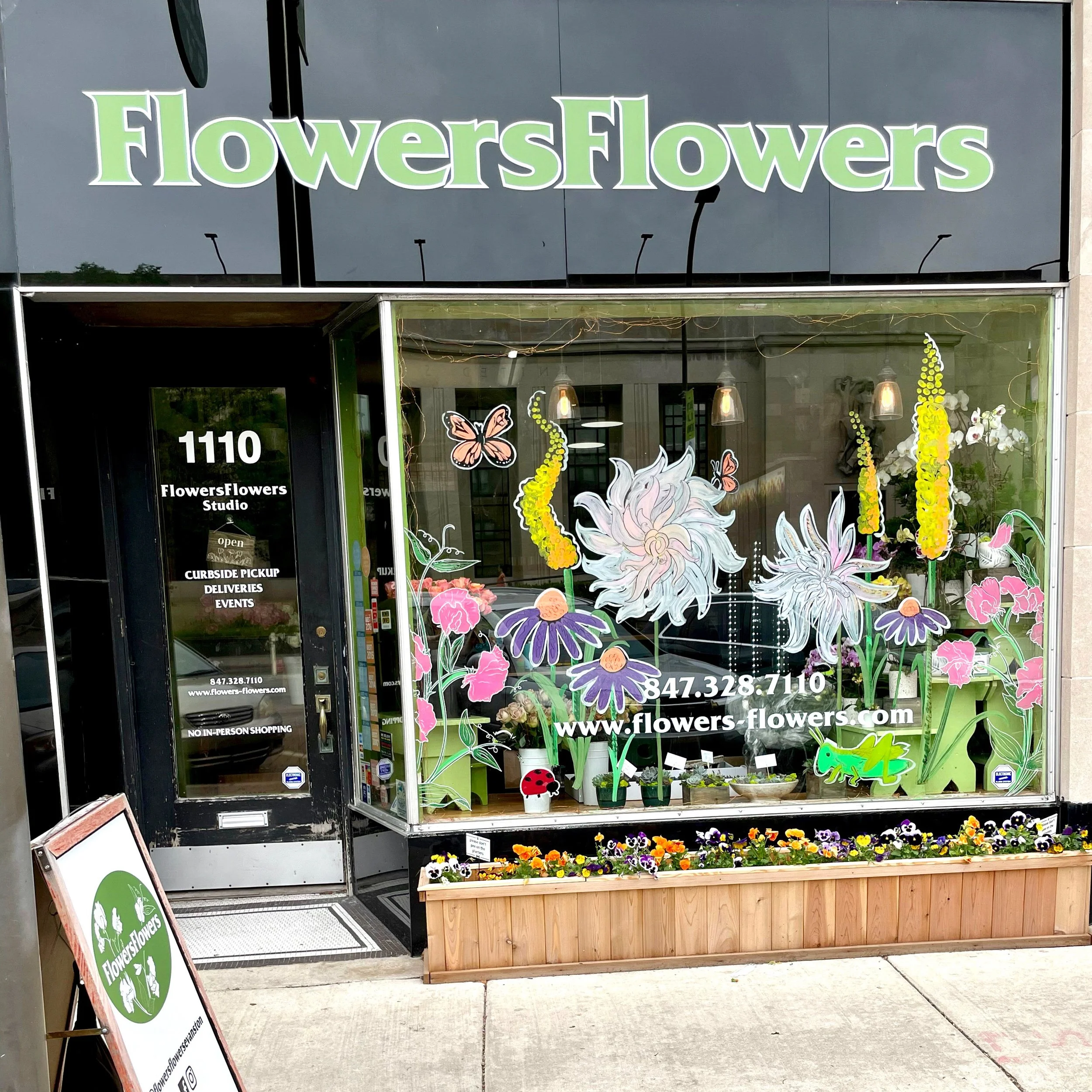 FlowersFlowers storefront decorated with paintings of bright flowers — Evanstonflorist