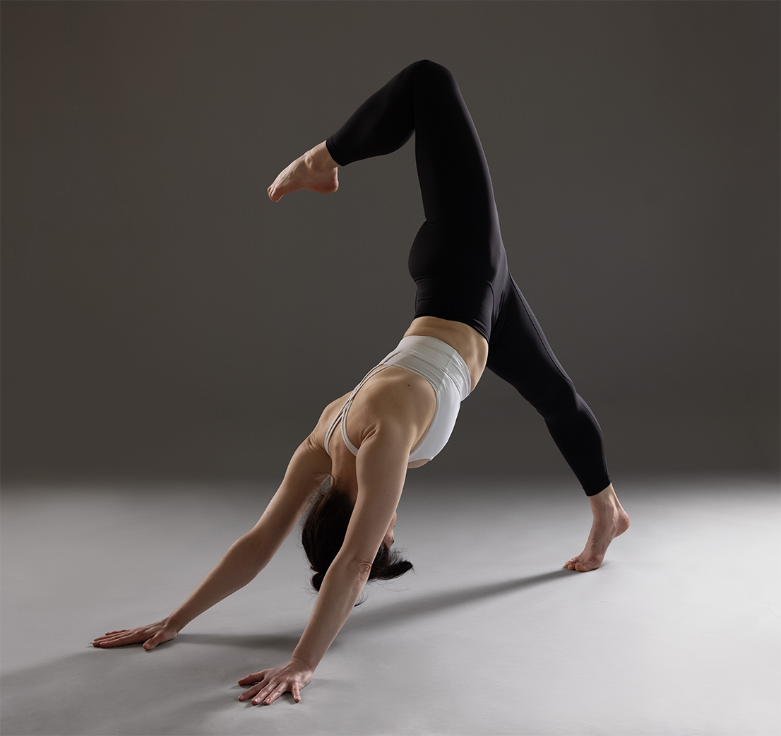 Elizabeth Voetsch practicing Tri Pada Adho Mukha Svanasana; offering Hudson Valley yoga classes in studio, online, and on-demand, yoga retreats, and yoga workshops.