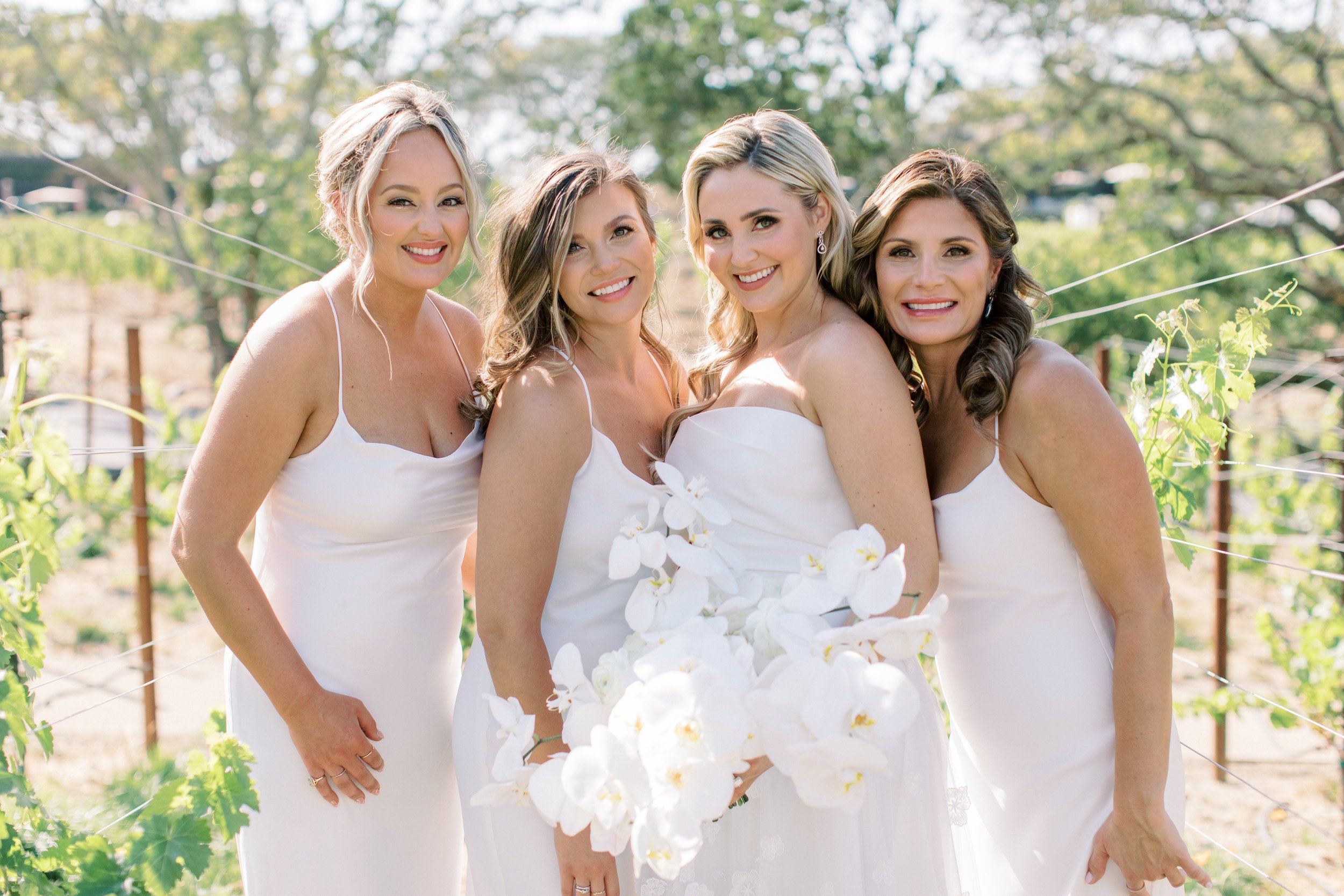 Bride holds bouquet of white orchids image name: wedding-florist-boise-424