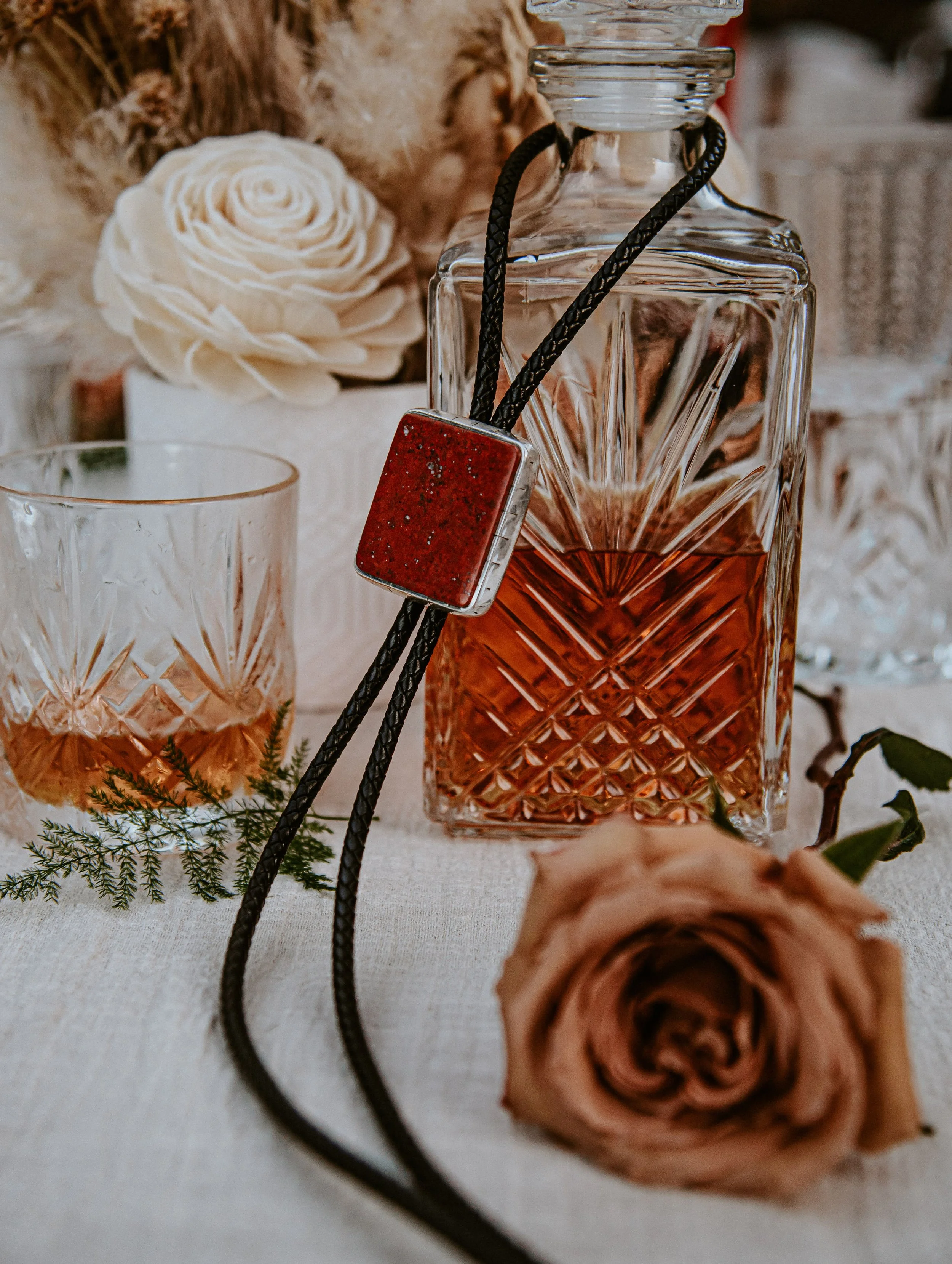 Rustic color rose whiskey decanter boa necktie Bay Area California. Image name: wedding-florist-boise-117